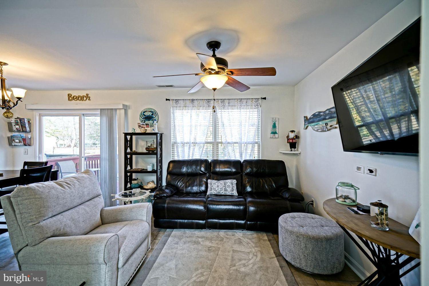 34531 Oakley Court, Unit 27 Lewes, DE 19958 - Photo 9 of 25 a living room with furniture and a flat screen tv