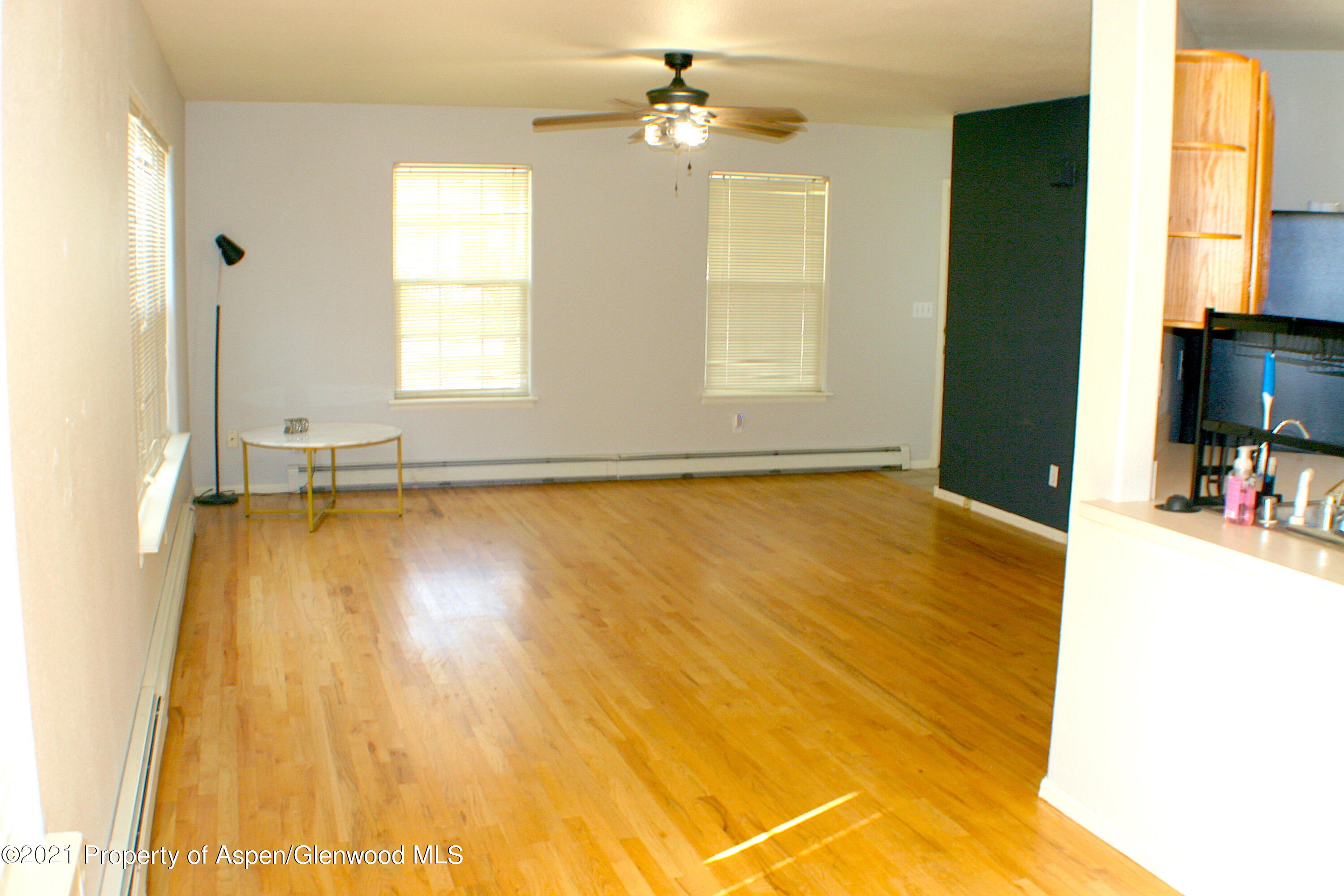 447 Columbine Drive Rifle, CO 81650 - Photo 16 of 36 a view of a livingroom with wooden floor and a ceiling fan