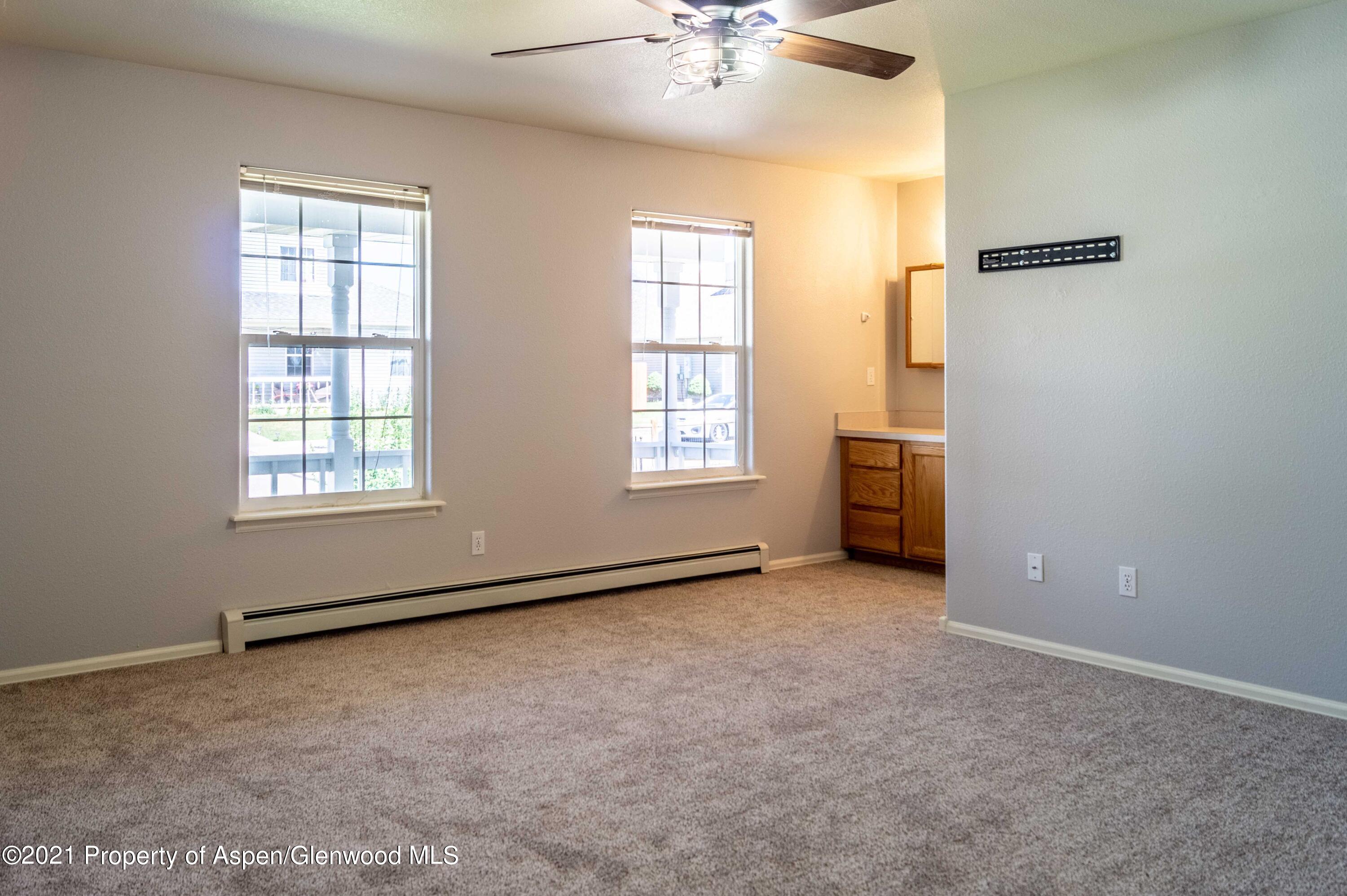 447 Columbine Drive Rifle, CO 81650 - Photo 19 of 36 an empty room with windows and closet