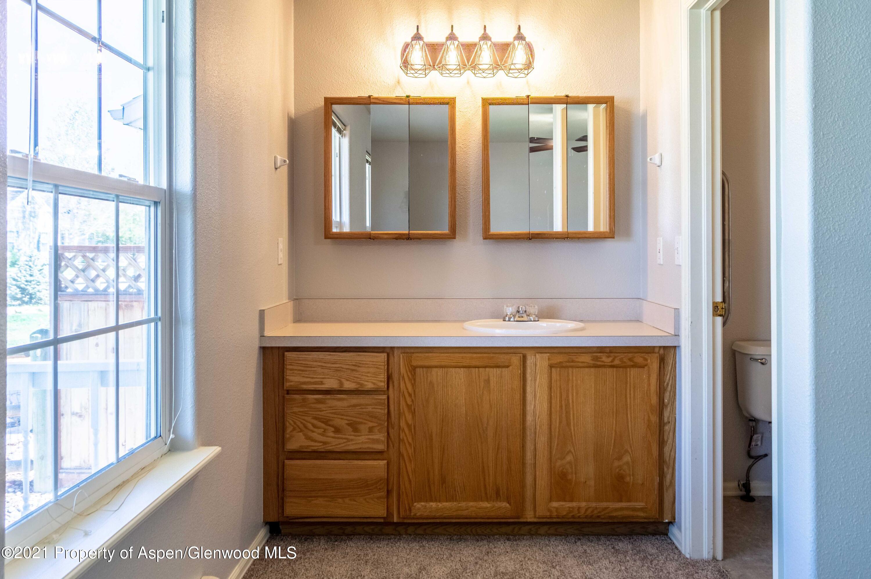 447 Columbine Drive Rifle, CO 81650 - Photo 22 of 36 a bathroom with a sink and a mirror