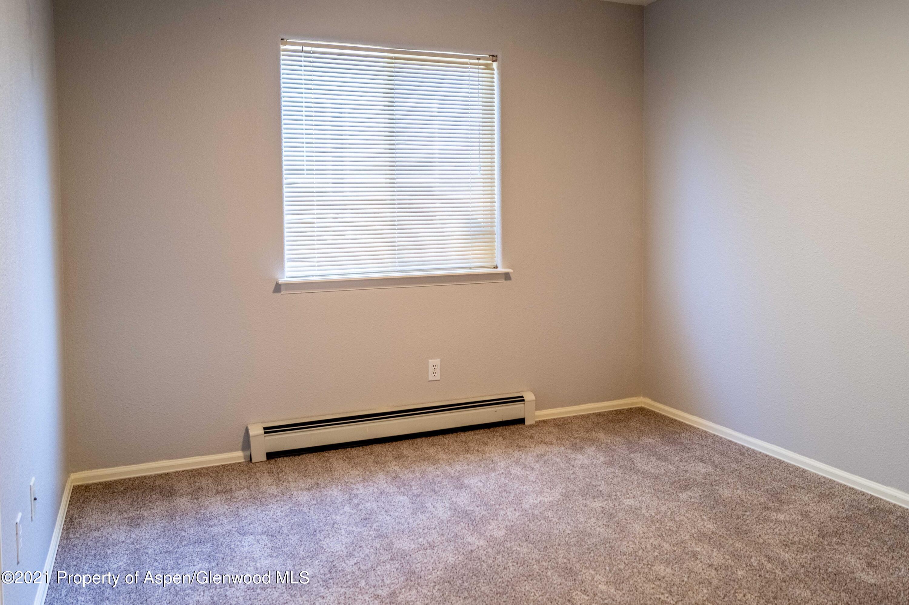 447 Columbine Drive Rifle, CO 81650 - Photo 24 of 36 an empty room with a window