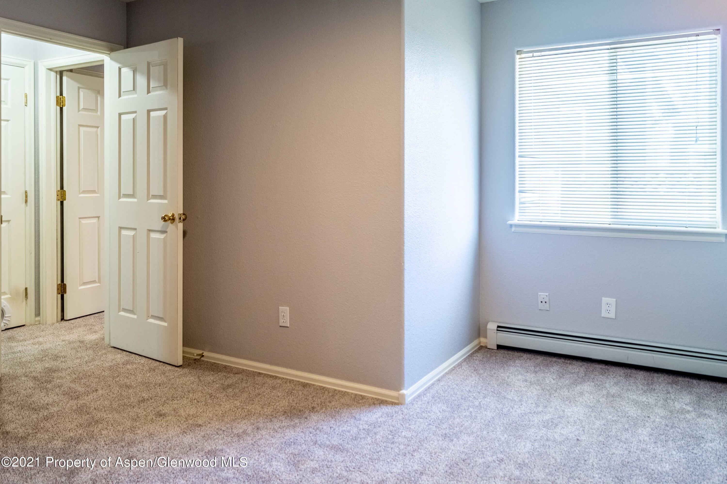 447 Columbine Drive Rifle, CO 81650 - Photo 28 of 36 an empty room with windows and closet