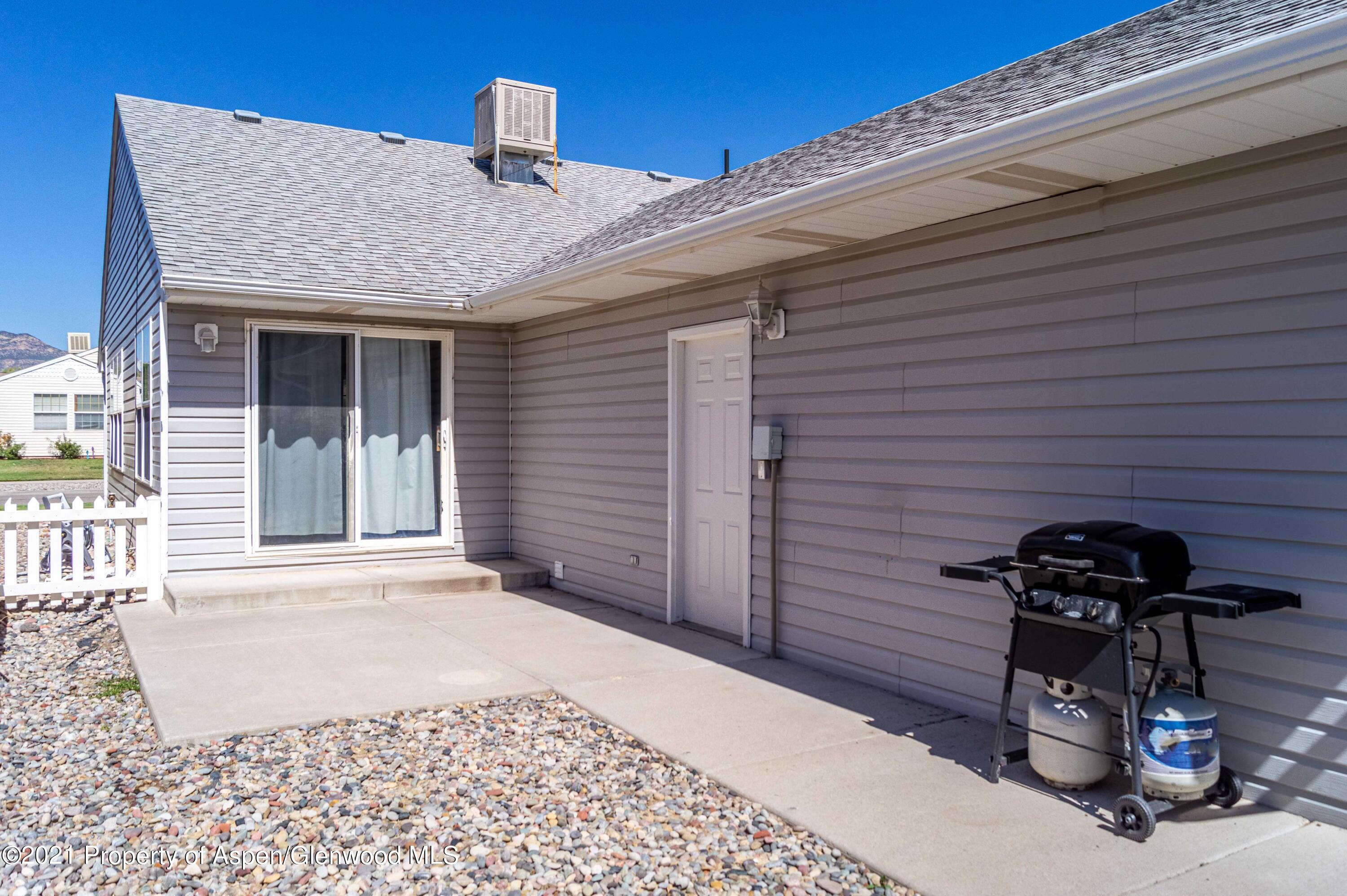 447 Columbine Drive Rifle, CO 81650 - Photo 10 of 36 a view of a house with a yard and table and chairs