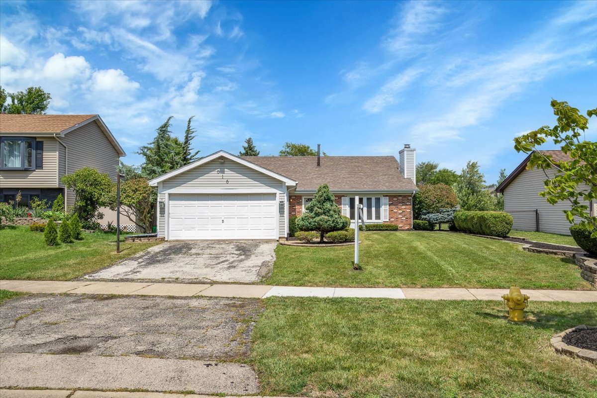 616 Rockhurst Road Bolingbrook, IL 60440 - Photo 1 of 37 a front view of a house with a yard and garage