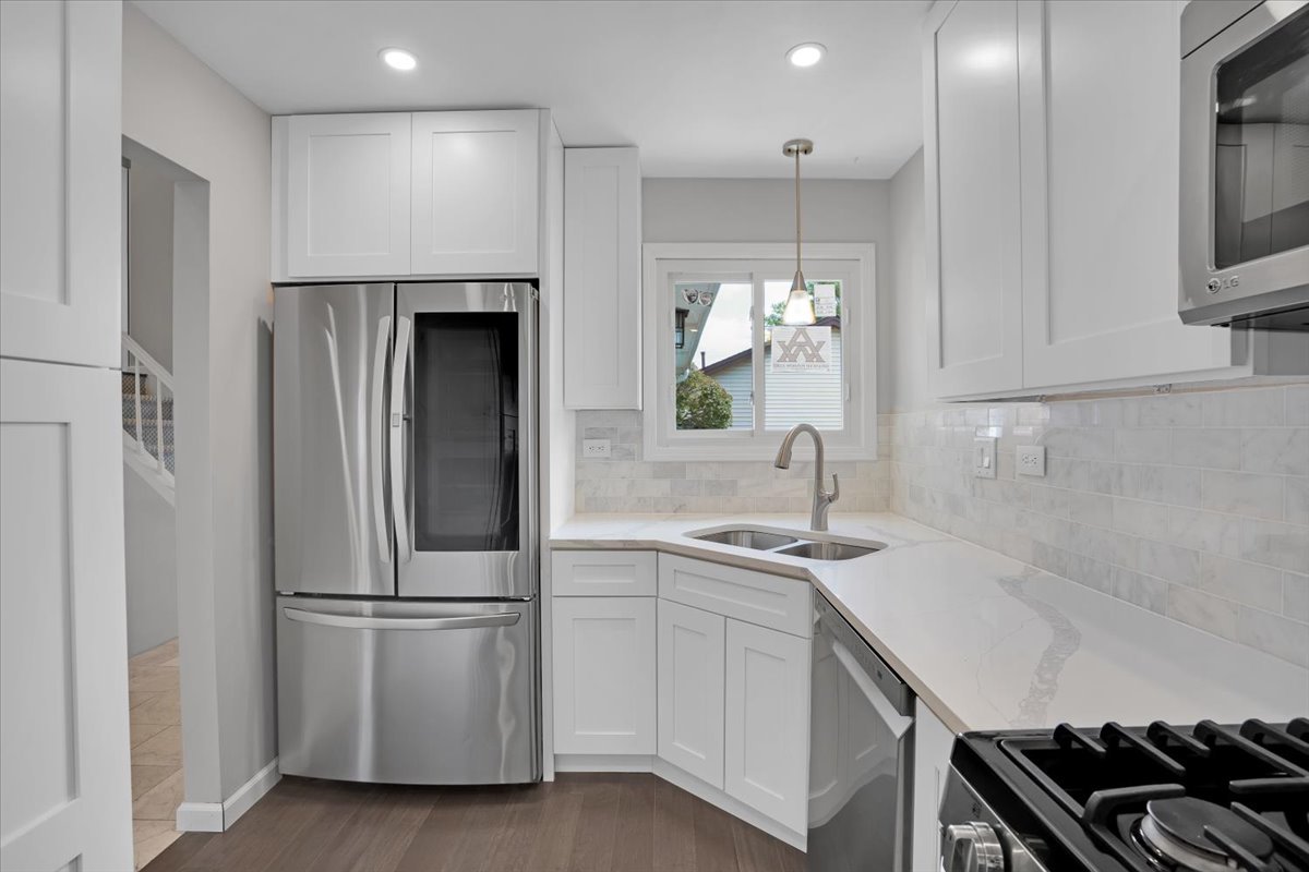 616 Rockhurst Road Bolingbrook, IL 60440 - Photo 11 of 37 a kitchen with stainless steel appliances a refrigerator a sink a stove and cabinets