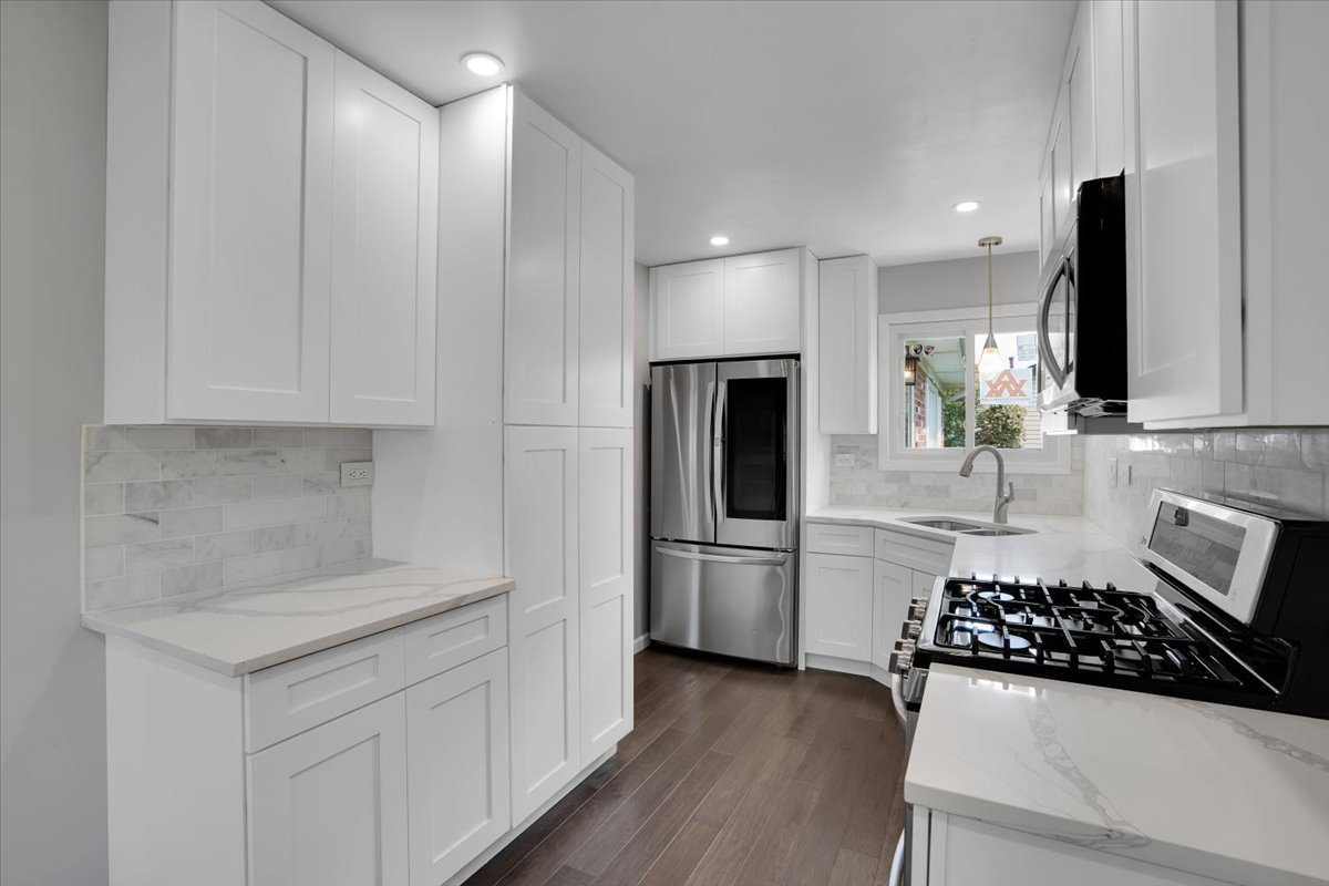 616 Rockhurst Road Bolingbrook, IL 60440 - Photo 12 of 37 a kitchen with stainless steel appliances a sink a stove a refrigerator and cabinets