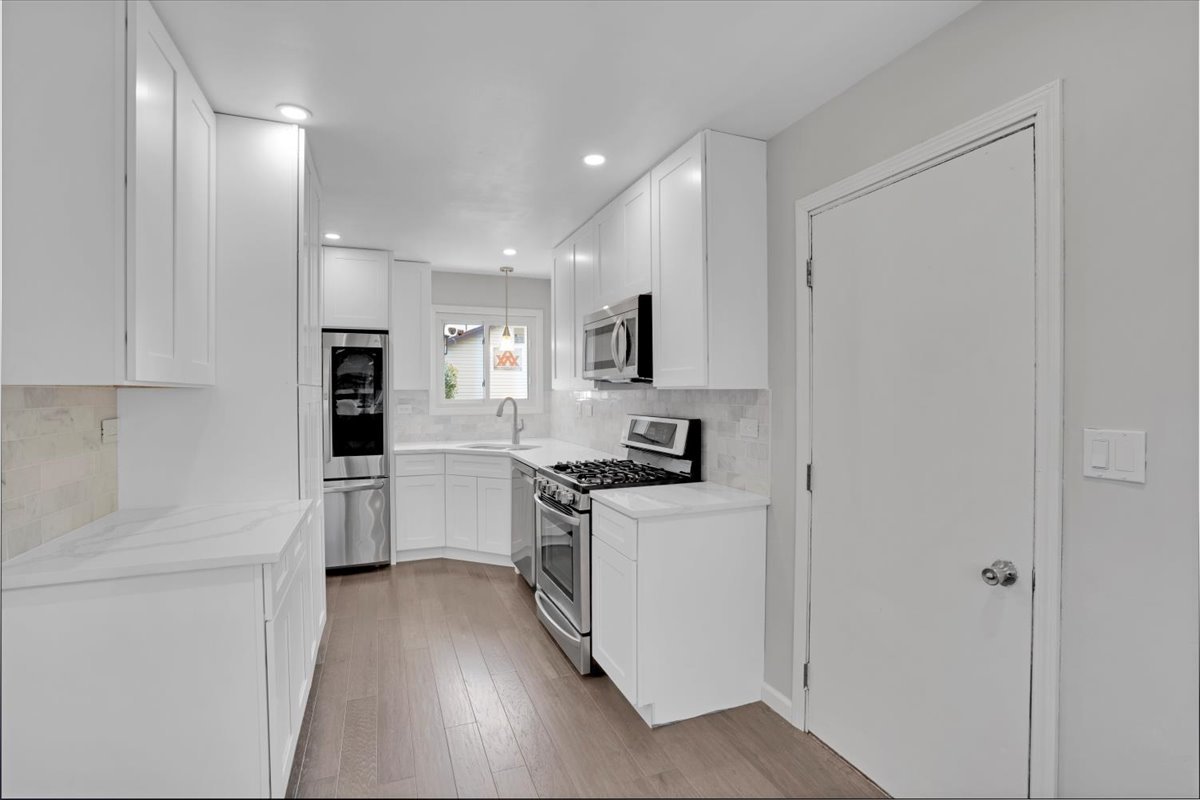 616 Rockhurst Road Bolingbrook, IL 60440 - Photo 14 of 37 a kitchen with white cabinets and white appliances