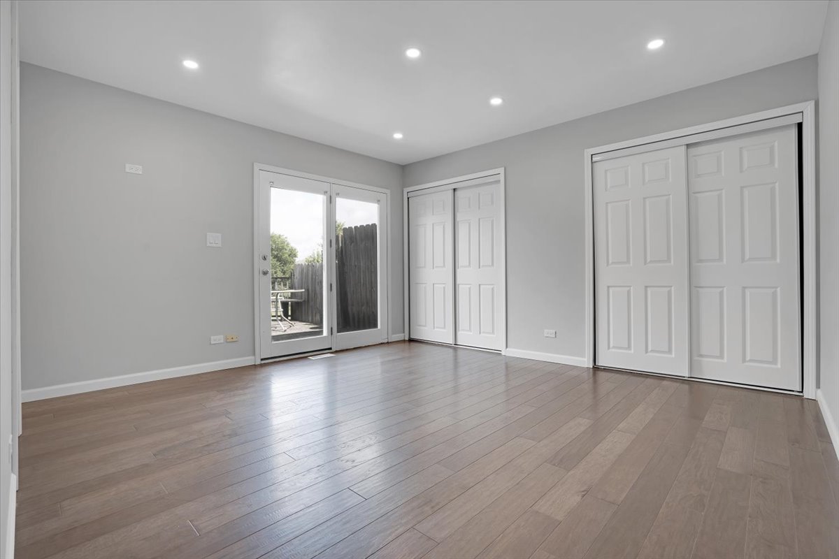 616 Rockhurst Road Bolingbrook, IL 60440 - Photo 17 of 37 a view of an empty room with wooden floor and windows