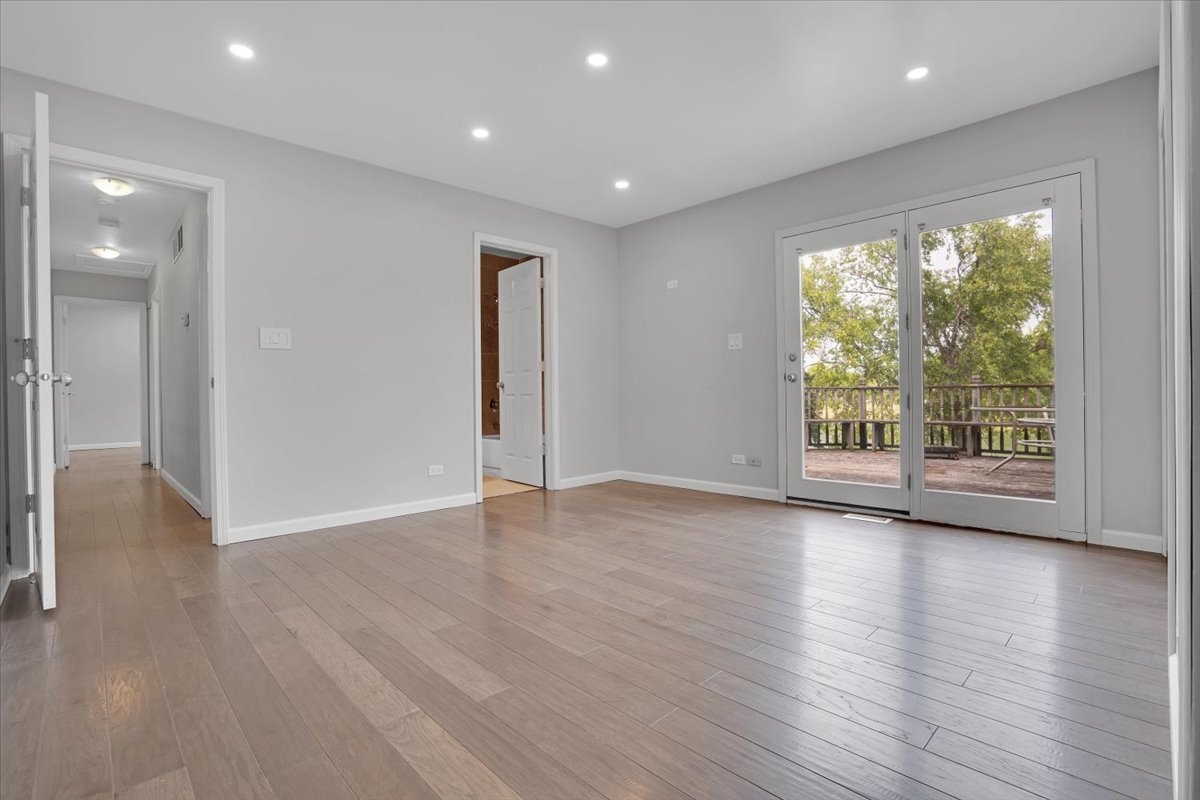 616 Rockhurst Road Bolingbrook, IL 60440 - Photo 19 of 37 a view of an empty room with wooden floor and a window