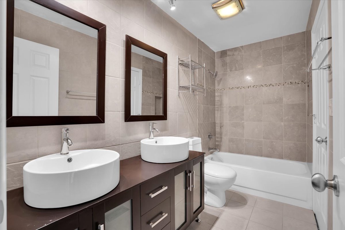 616 Rockhurst Road Bolingbrook, IL 60440 - Photo 20 of 37 a bathroom with a double vanity sink toilet mirror and bathtub