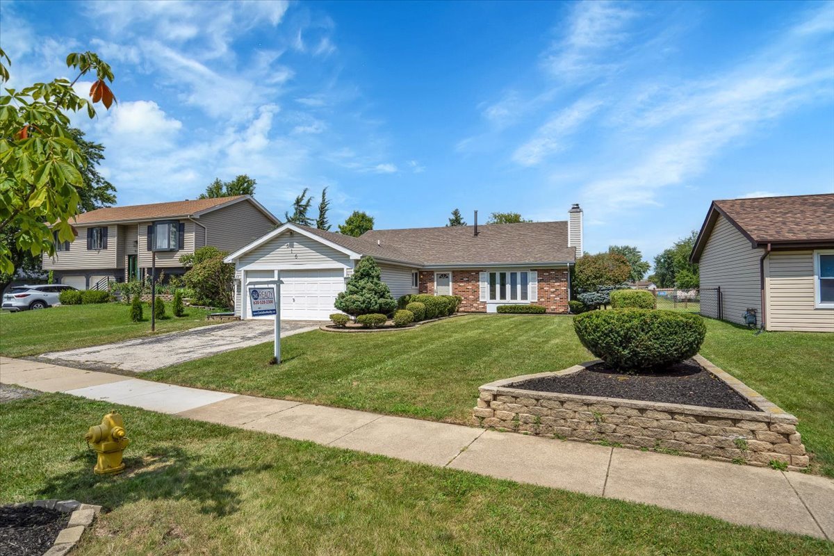 616 Rockhurst Road Bolingbrook, IL 60440 - Photo 2 of 37 a front view of a house with a yard