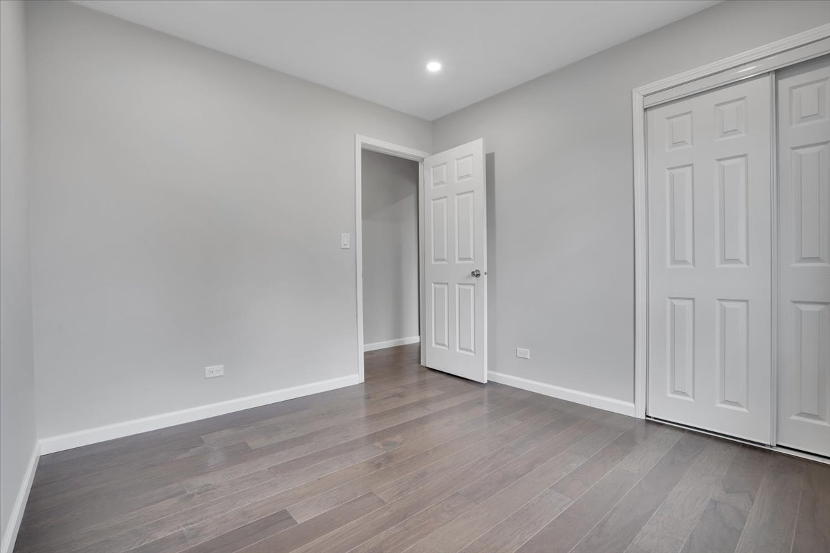 616 Rockhurst Road Bolingbrook, IL 60440 - Photo 22 of 37 a view of an empty room with wooden floor