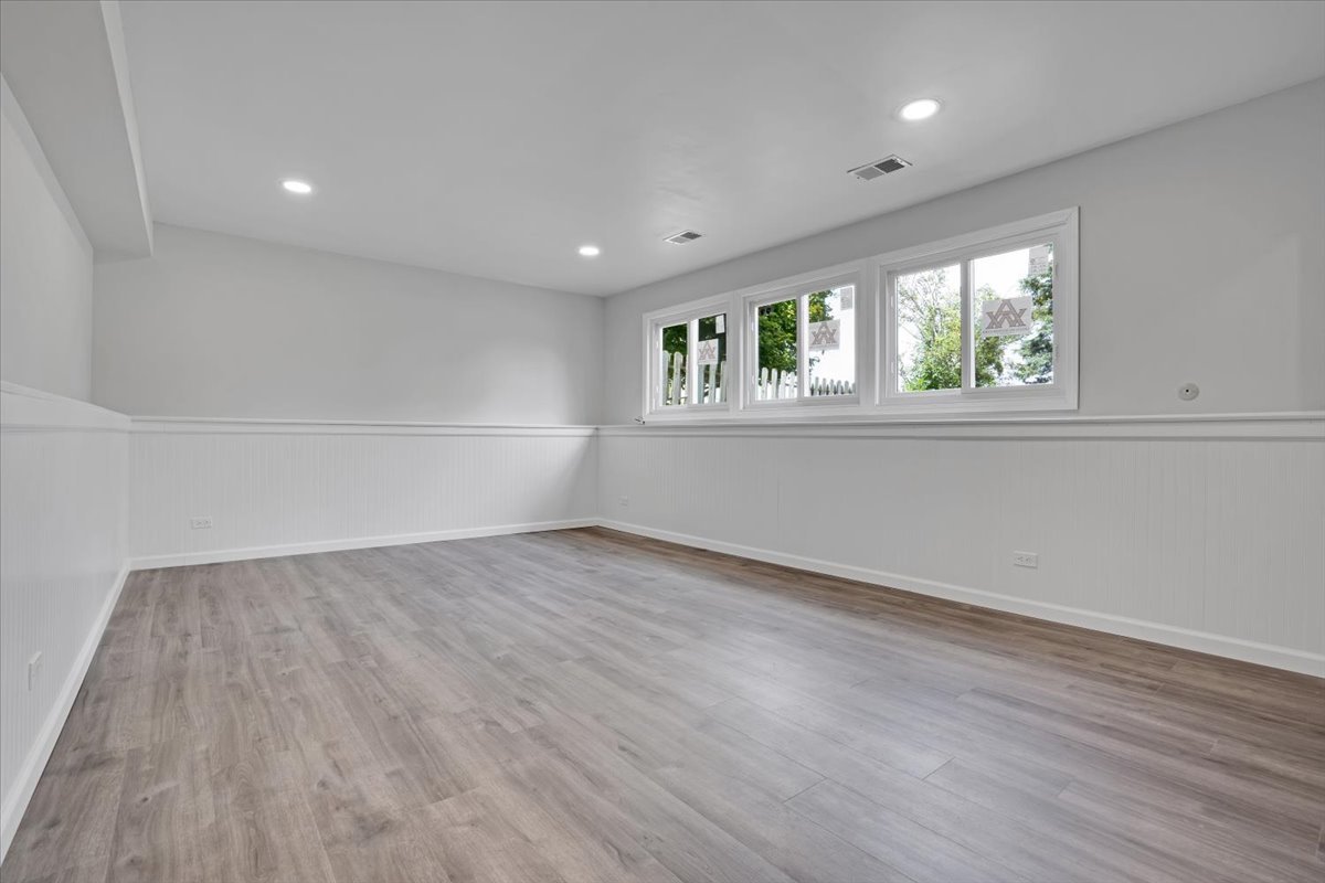616 Rockhurst Road Bolingbrook, IL 60440 - Photo 25 of 37 an empty room with wooden floor and windows