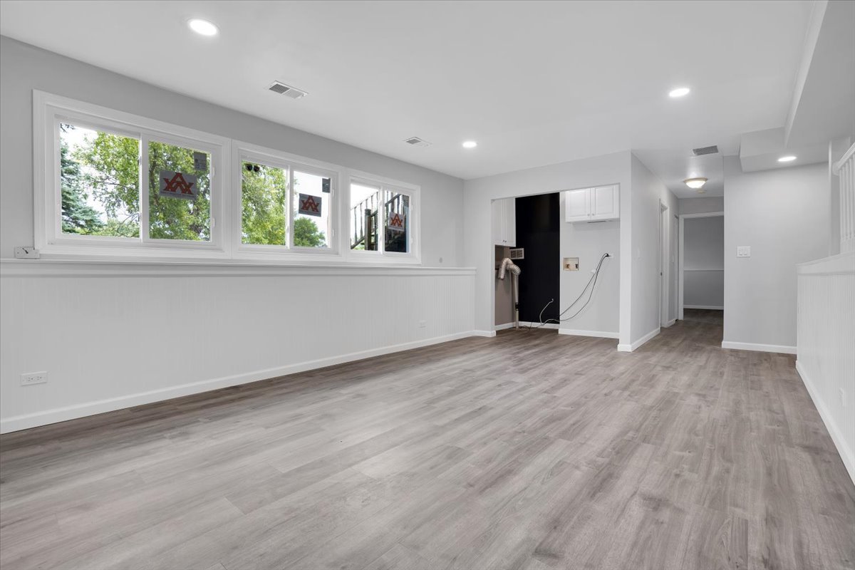 616 Rockhurst Road Bolingbrook, IL 60440 - Photo 27 of 37 an empty room with wooden floor and windows