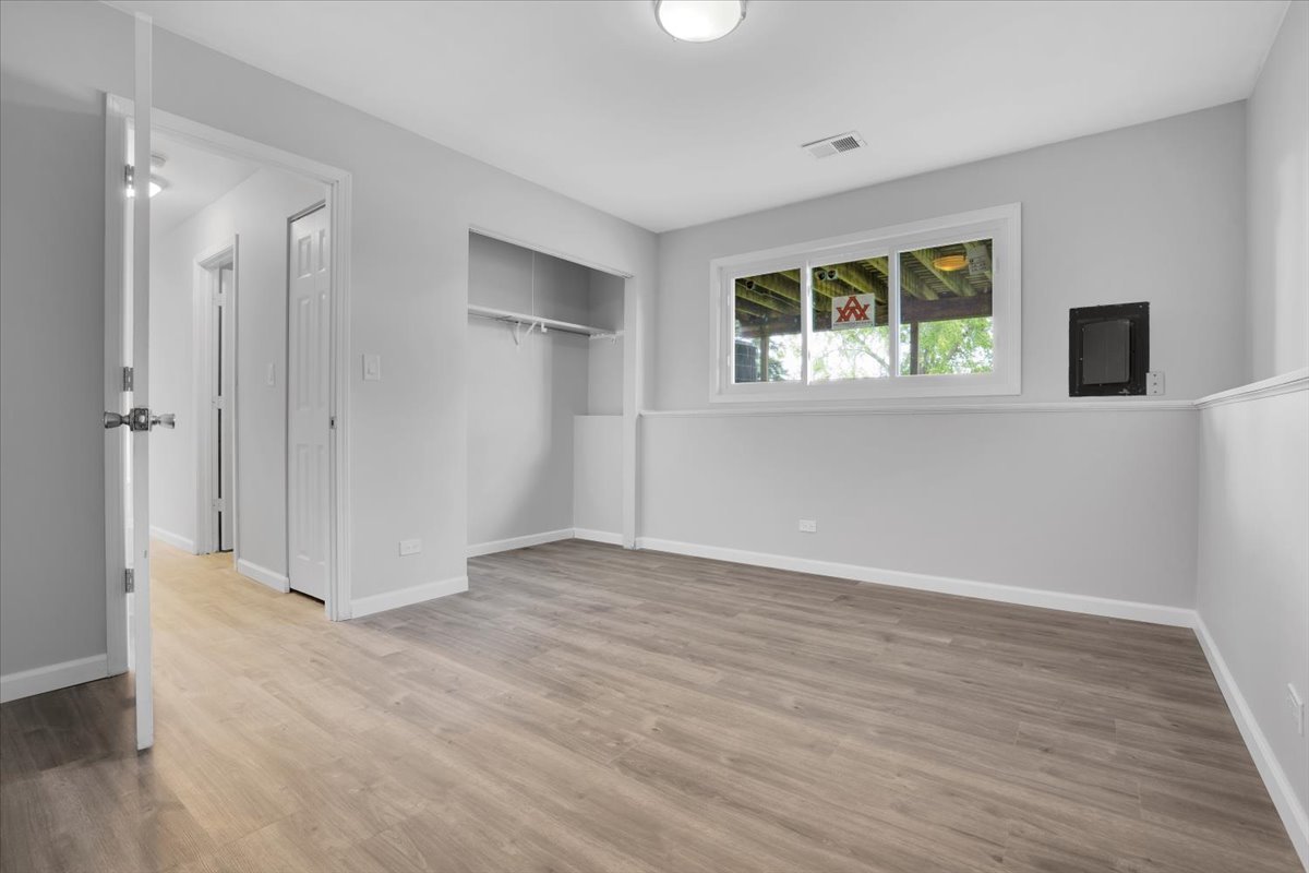 616 Rockhurst Road Bolingbrook, IL 60440 - Photo 28 of 37 a view of an empty room with window and wooden floor