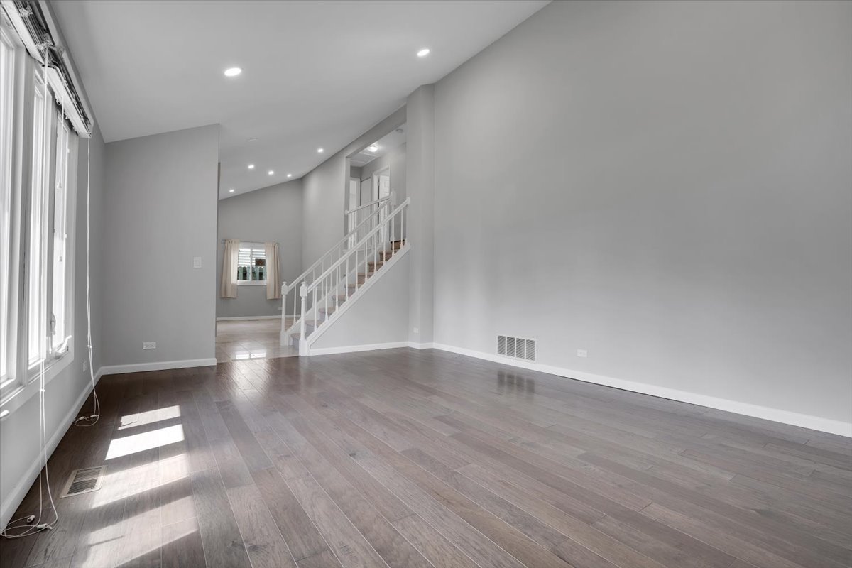 616 Rockhurst Road Bolingbrook, IL 60440 - Photo 6 of 37 a view of an empty room with wooden floor and a window