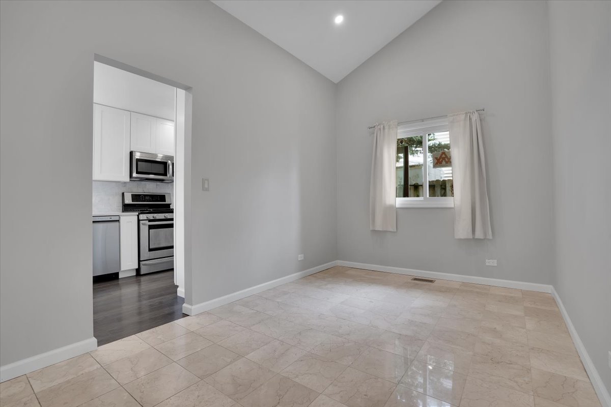 616 Rockhurst Road Bolingbrook, IL 60440 - Photo 8 of 37 an empty room with windows and cabinet