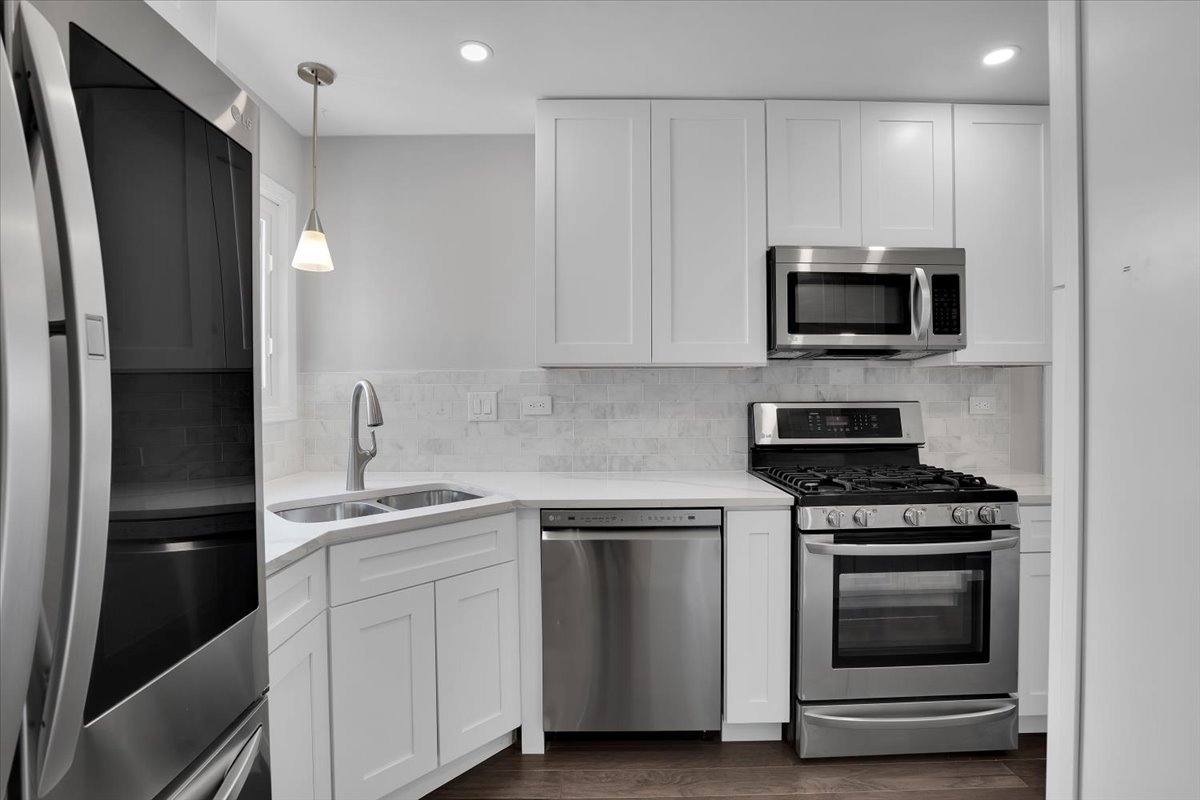 616 Rockhurst Road Bolingbrook, IL 60440 - Photo 10 of 37 a kitchen with white cabinets and stainless steel appliances