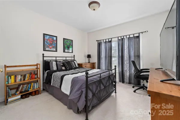 a bedroom with a bed furniture and a window
