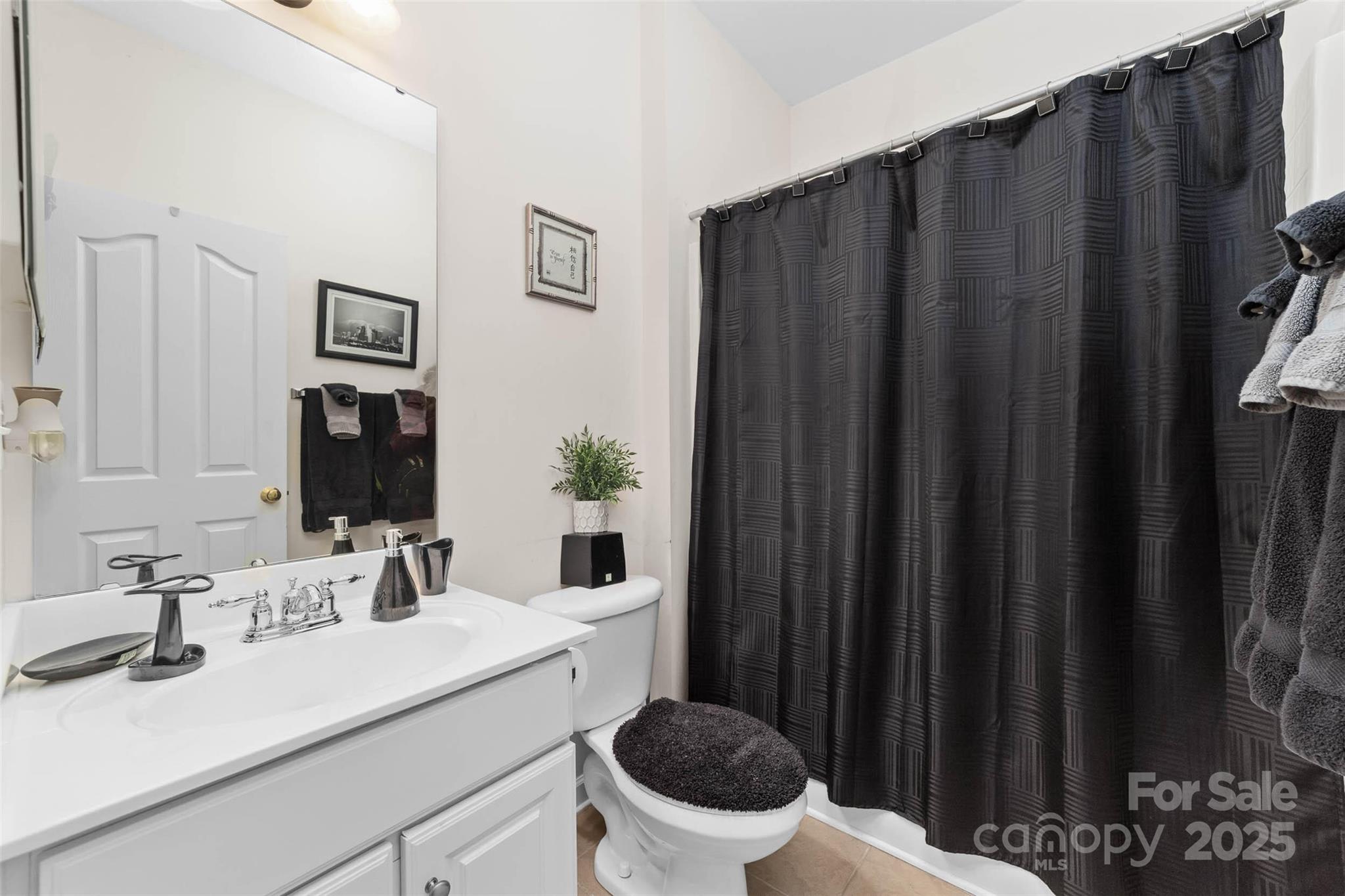 1728 Copperplate Road Charlotte, NC 28262 - Photo 20 of 36 a bathroom with a sink and a mirror