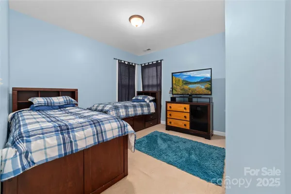 a bedroom with a bed and a television in it