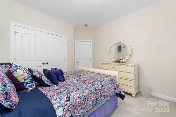 a bedroom with a bed and dresser