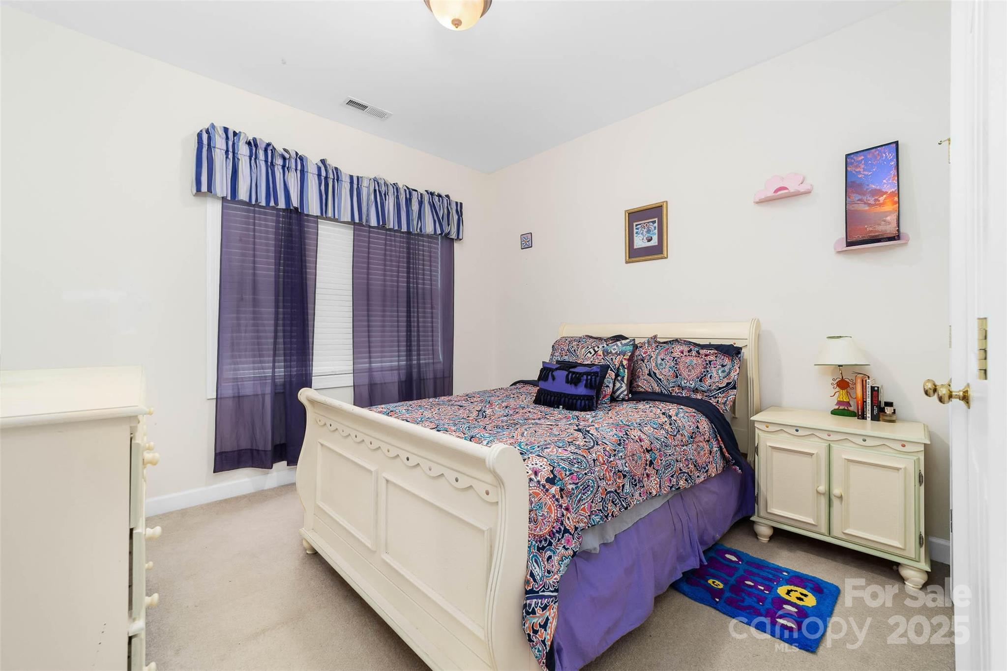 1728 Copperplate Road Charlotte, NC 28262 - Photo 24 of 36 a bedroom with a bed and a chandelier