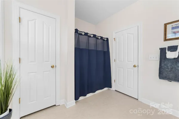 a view of a closet area with ceiling fan