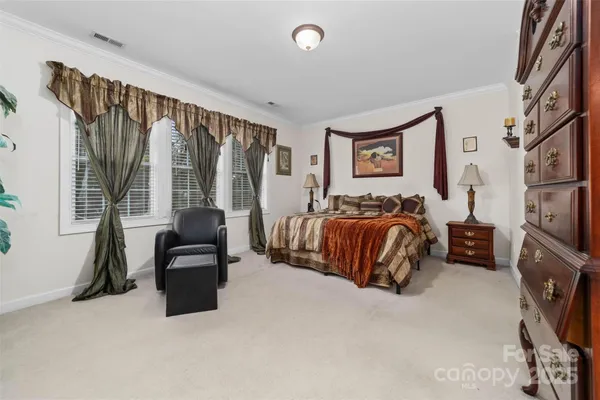 a bedroom with furniture and a flat screen tv