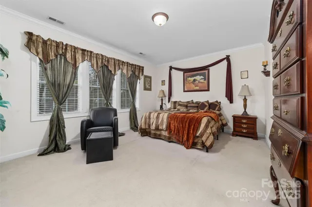 a bedroom with furniture and a flat screen tv