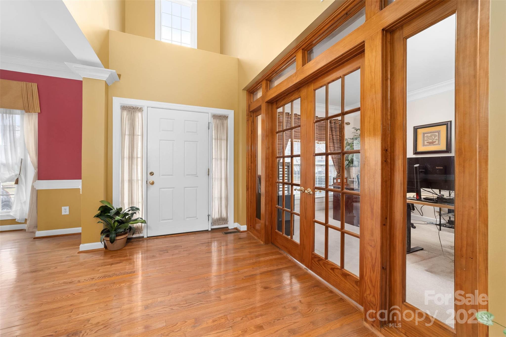 1728 Copperplate Road Charlotte, NC 28262 - Photo 4 of 36 a view of an entryway with wooden floor and a potted plant