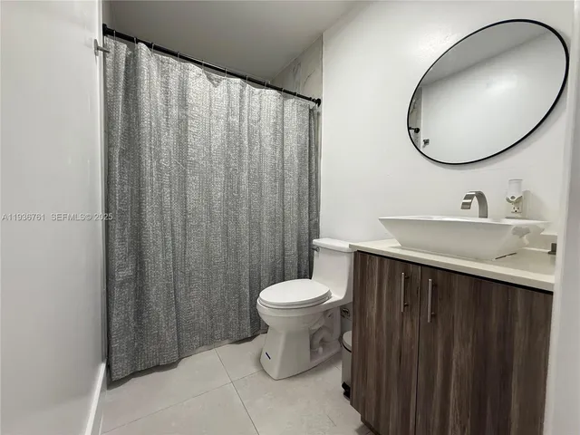 a bathroom with a sink vanity and a toilet