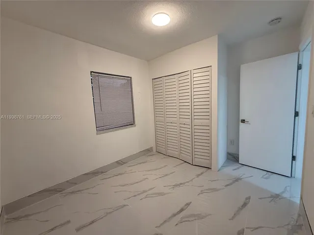 an empty room with a empty space and windows