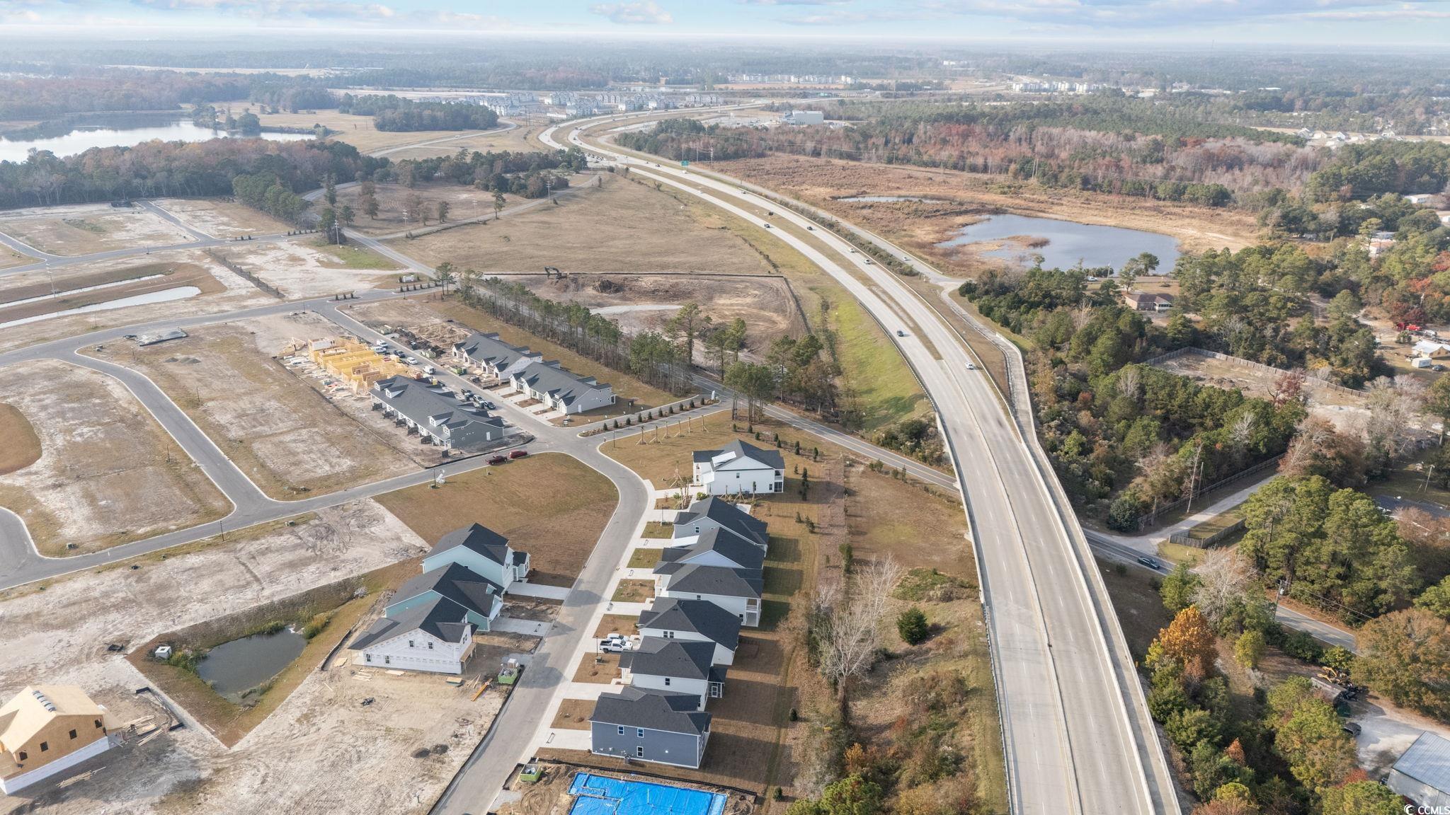 774 Ebb Tide Road Little River, SC 29566 - Photo 11 of 39 Aerial view of property and surrounding area with a large body of water
