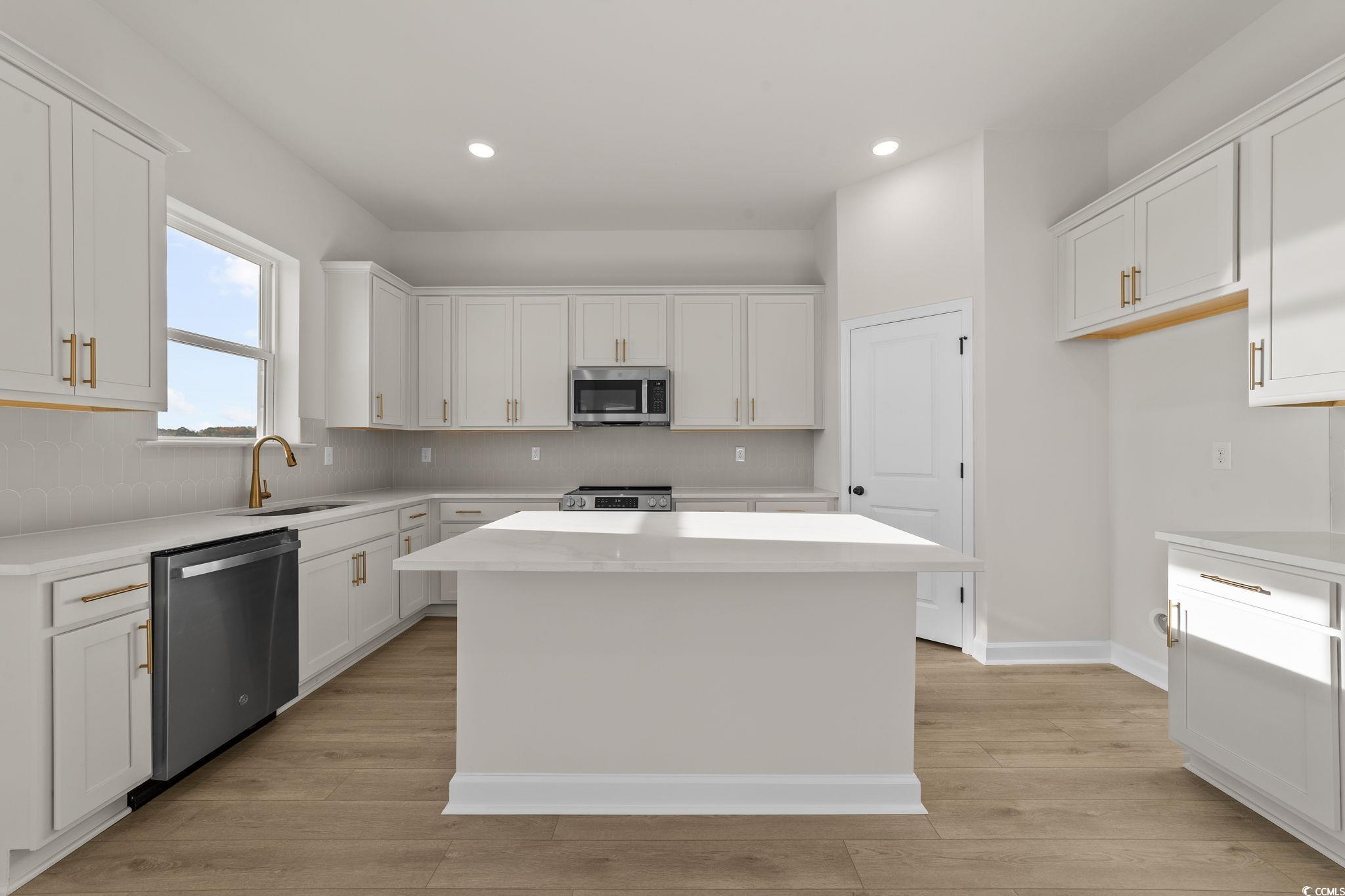 774 Ebb Tide Road Little River, SC 29566 - Photo 18 of 39 Unfurnished living room featuring light wood finished floors, recessed lighting, and a chandelier