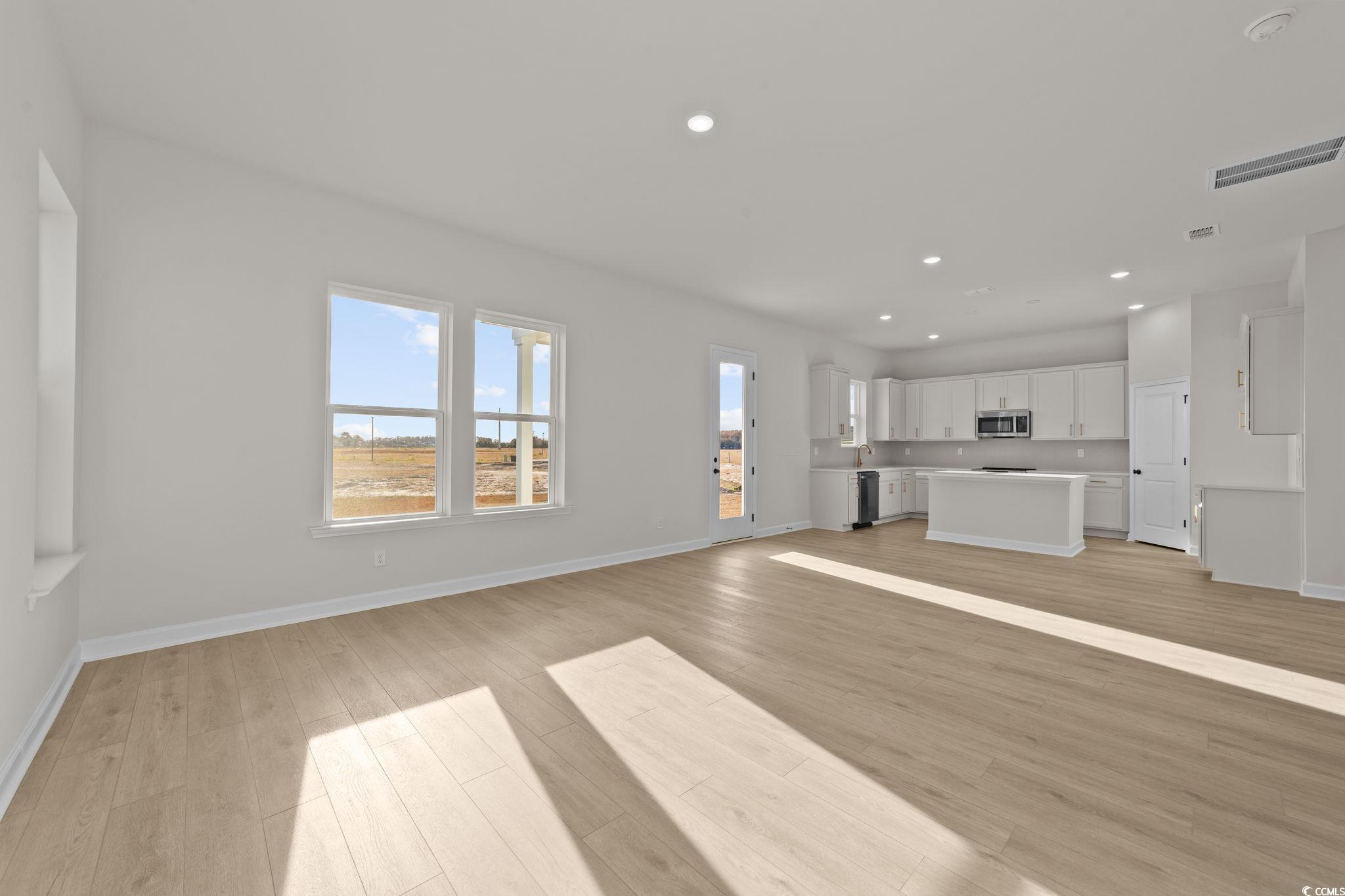 774 Ebb Tide Road Little River, SC 29566 - Photo 23 of 39 Empty room featuring light wood finished floors, a chandelier, and recessed lighting