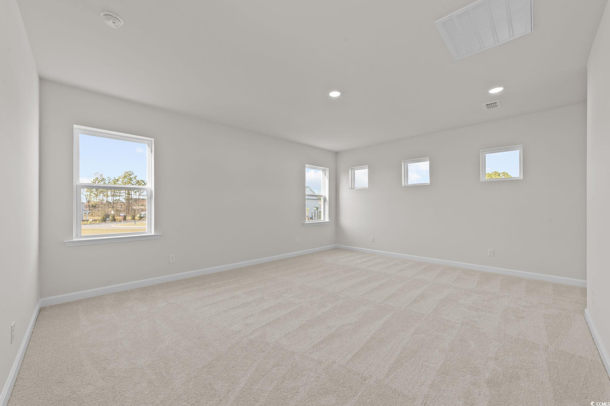 774 Ebb Tide Road Little River, SC 29566 - Photo 25 of 39 Hallway with light carpet and baseboards