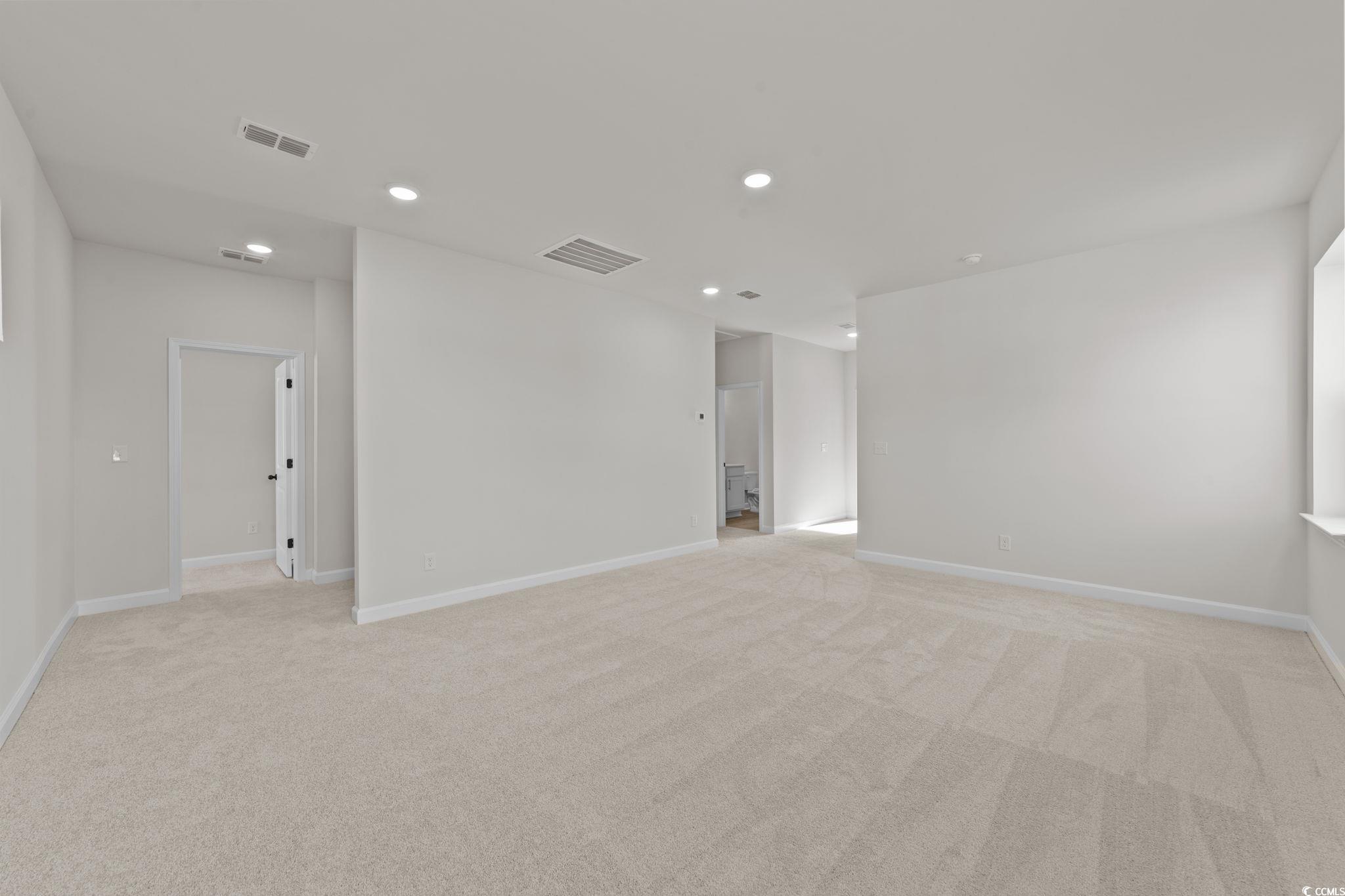 774 Ebb Tide Road Little River, SC 29566 - Photo 26 of 39 Empty room with light colored carpet, healthy amount of natural light, and recessed lighting