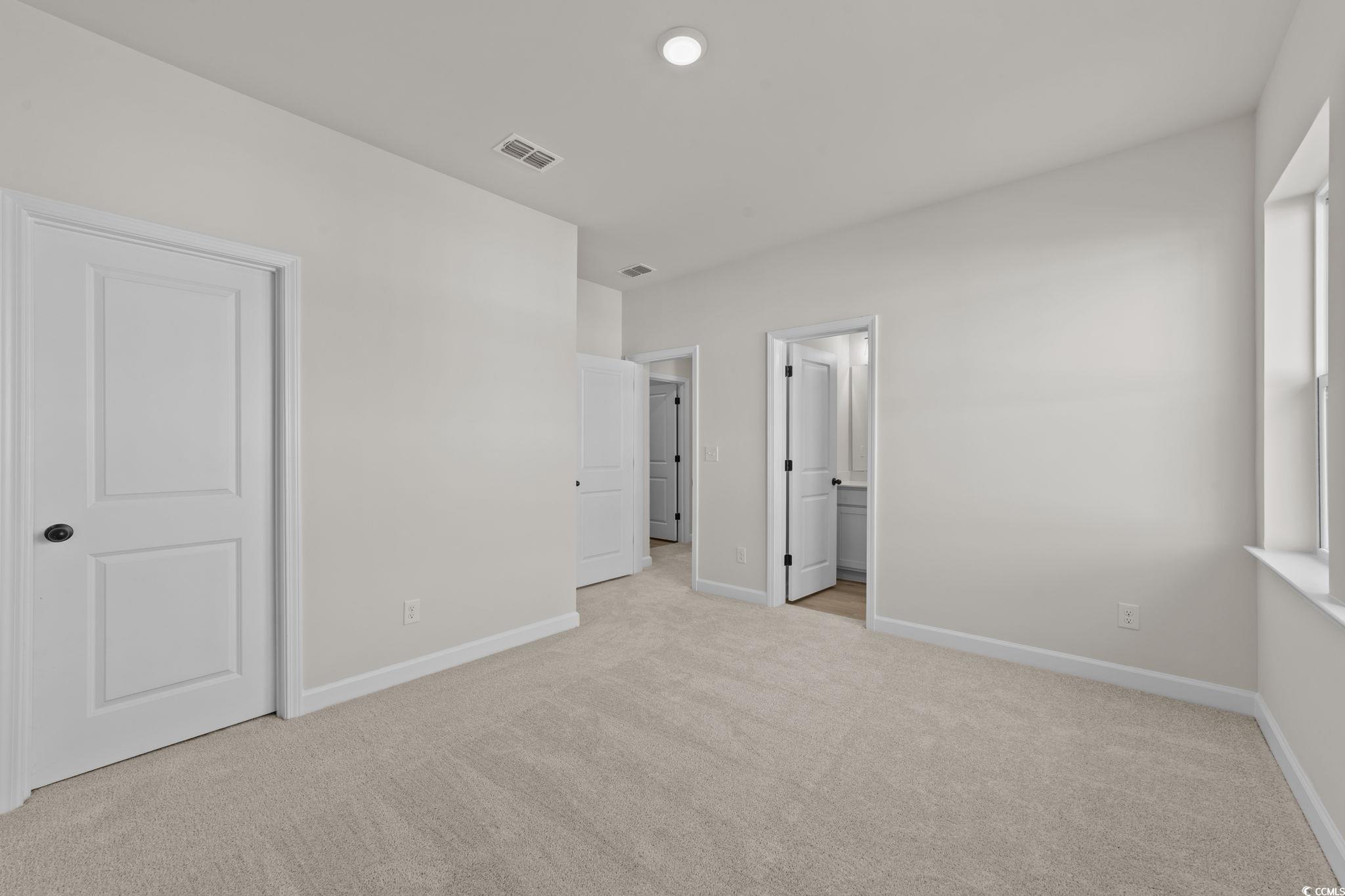 774 Ebb Tide Road Little River, SC 29566 - Photo 29 of 39 Empty room with light carpet and baseboards