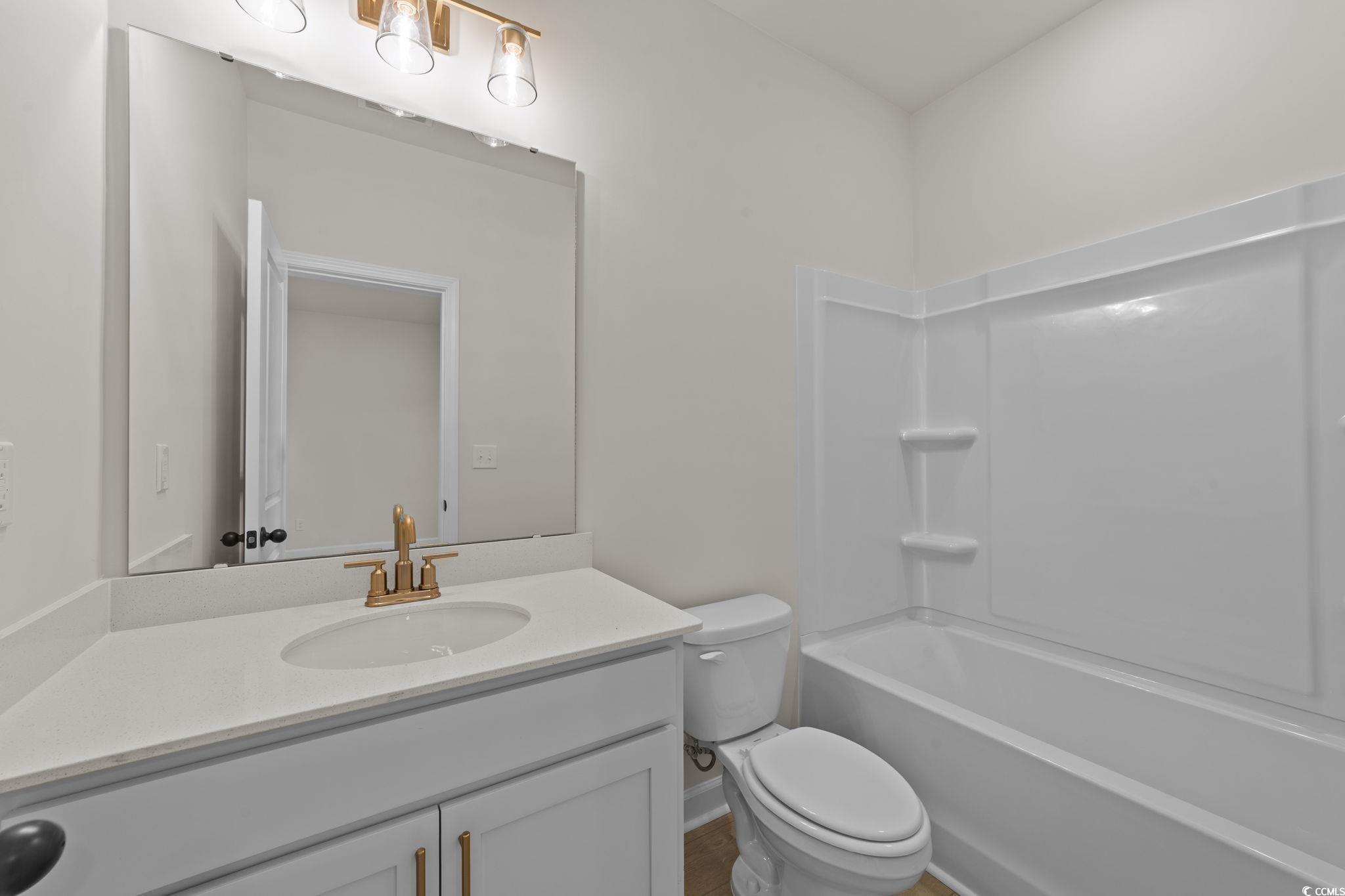 774 Ebb Tide Road Little River, SC 29566 - Photo 30 of 39 Unfurnished bedroom with light carpet and ensuite bath