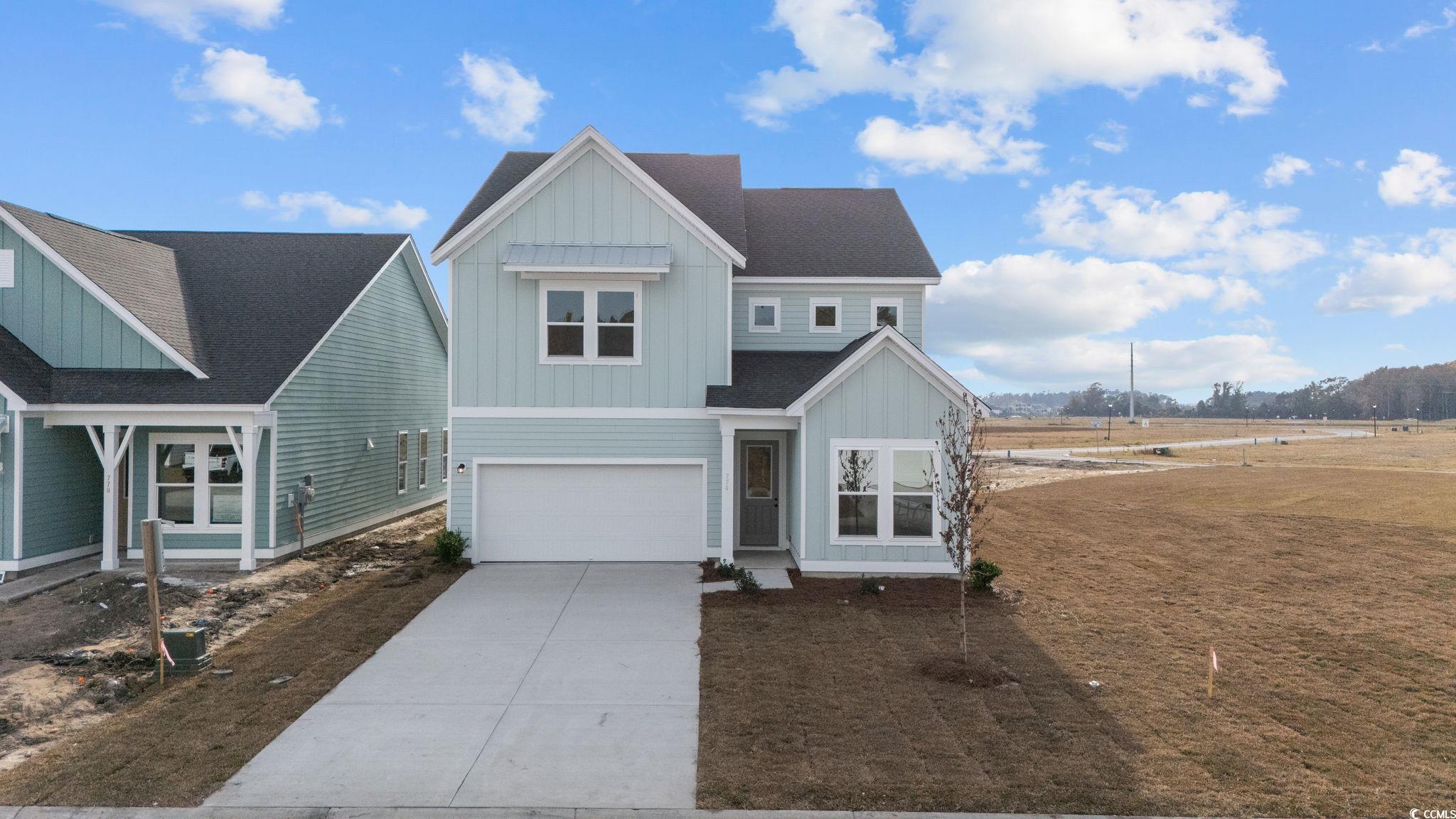 774 Ebb Tide Road Little River, SC 29566 - Photo 3 of 39 View of front of home featuring board and batten siding, roof with shingles, driveway, a porch, and an attached garage