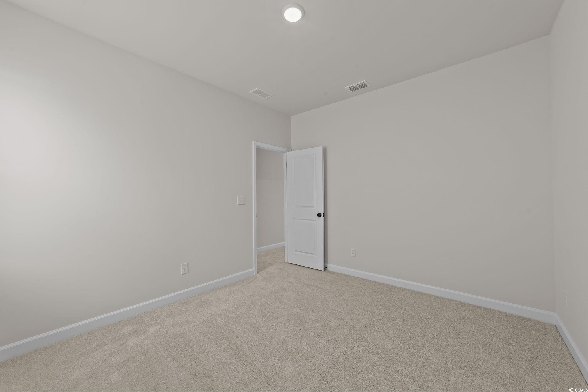 774 Ebb Tide Road Little River, SC 29566 - Photo 33 of 39 Unfurnished room with light carpet and baseboards