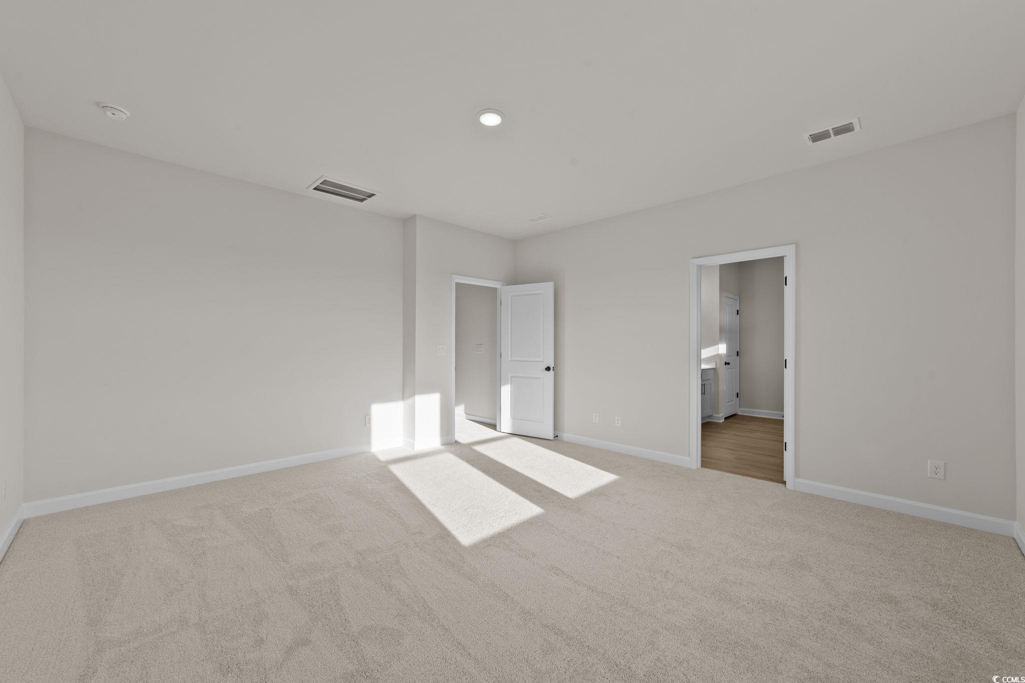 774 Ebb Tide Road Little River, SC 29566 - Photo 36 of 39 Unfurnished bedroom featuring light carpet and a closet