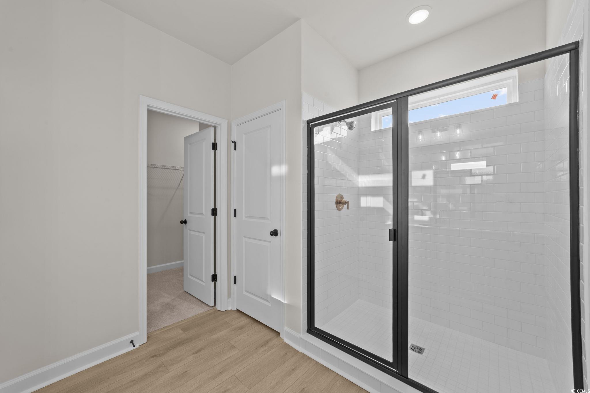 774 Ebb Tide Road Little River, SC 29566 - Photo 38 of 39 Bathroom with double vanity and a stall shower