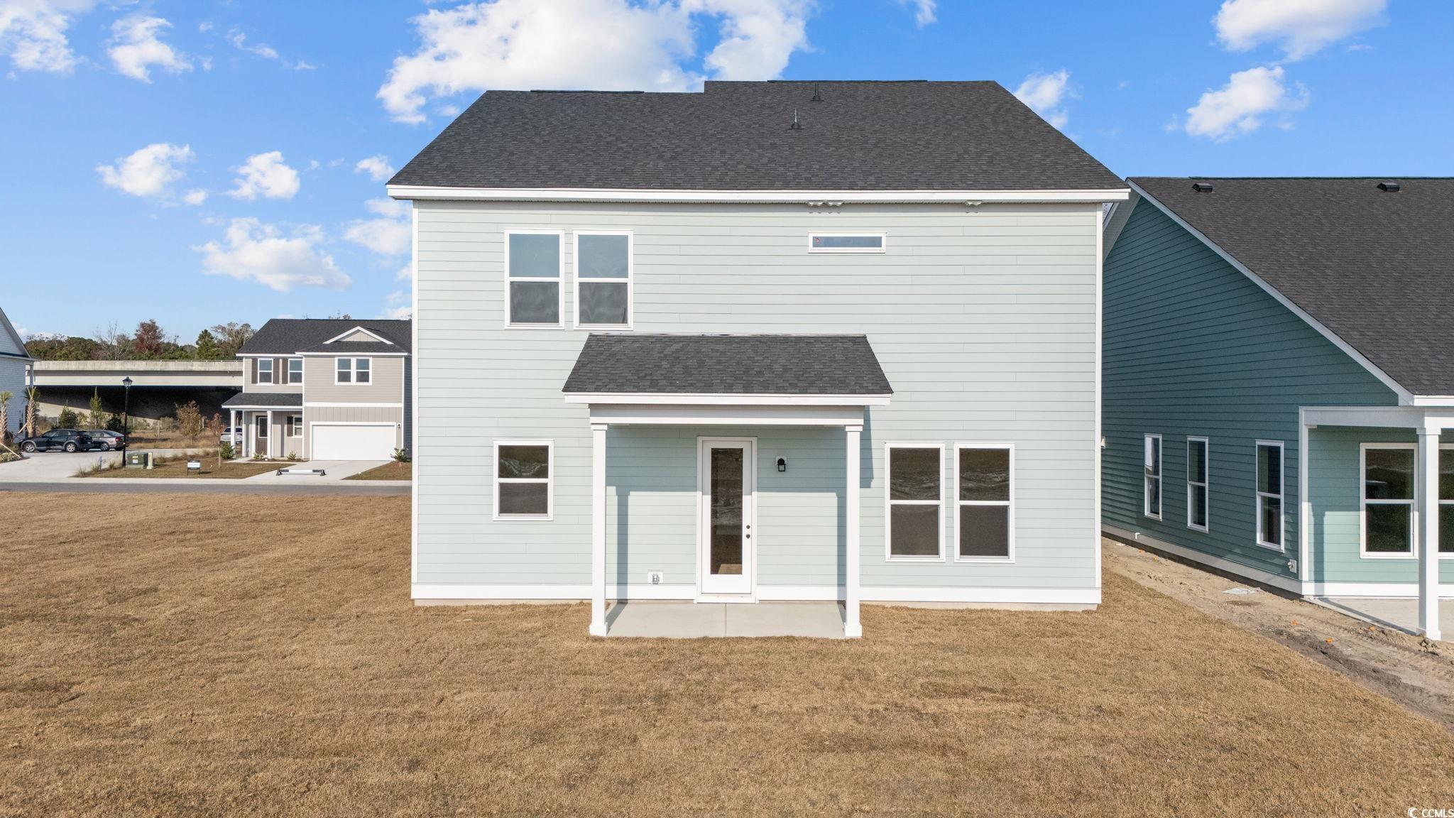 774 Ebb Tide Road Little River, SC 29566 - Photo 5 of 39 View of exterior entry featuring a garage and board and batten siding