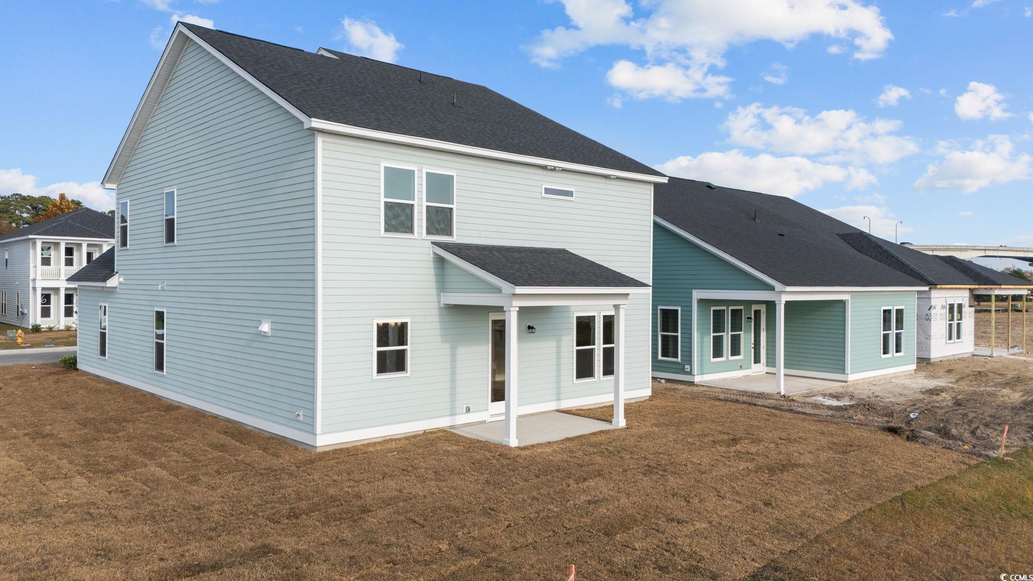 774 Ebb Tide Road Little River, SC 29566 - Photo 6 of 39 Back of house with a patio area, a shingled roof, and a yard