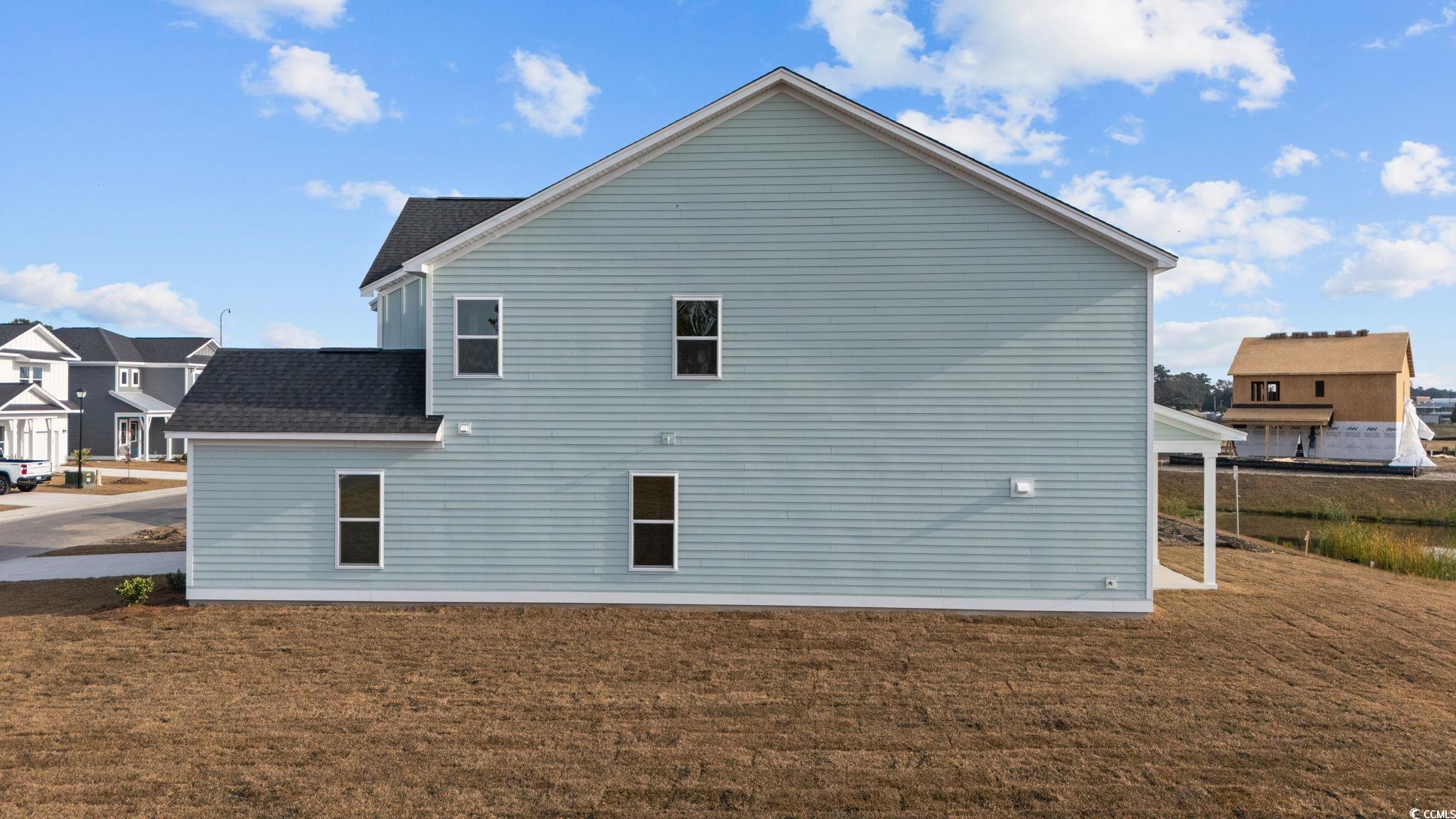 774 Ebb Tide Road Little River, SC 29566 - Photo 7 of 39 Back of property featuring a patio area, a shingled roof, and a yard