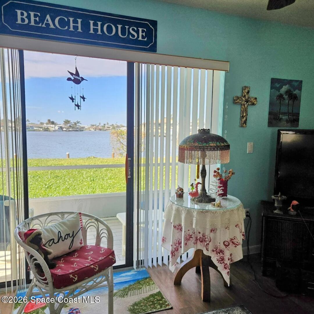 1750 Commodore Boulevard, Unit 2101 Cocoa Beach, FL 32931 - Photo 11 of 21 a living room with furniture and a flat screen tv