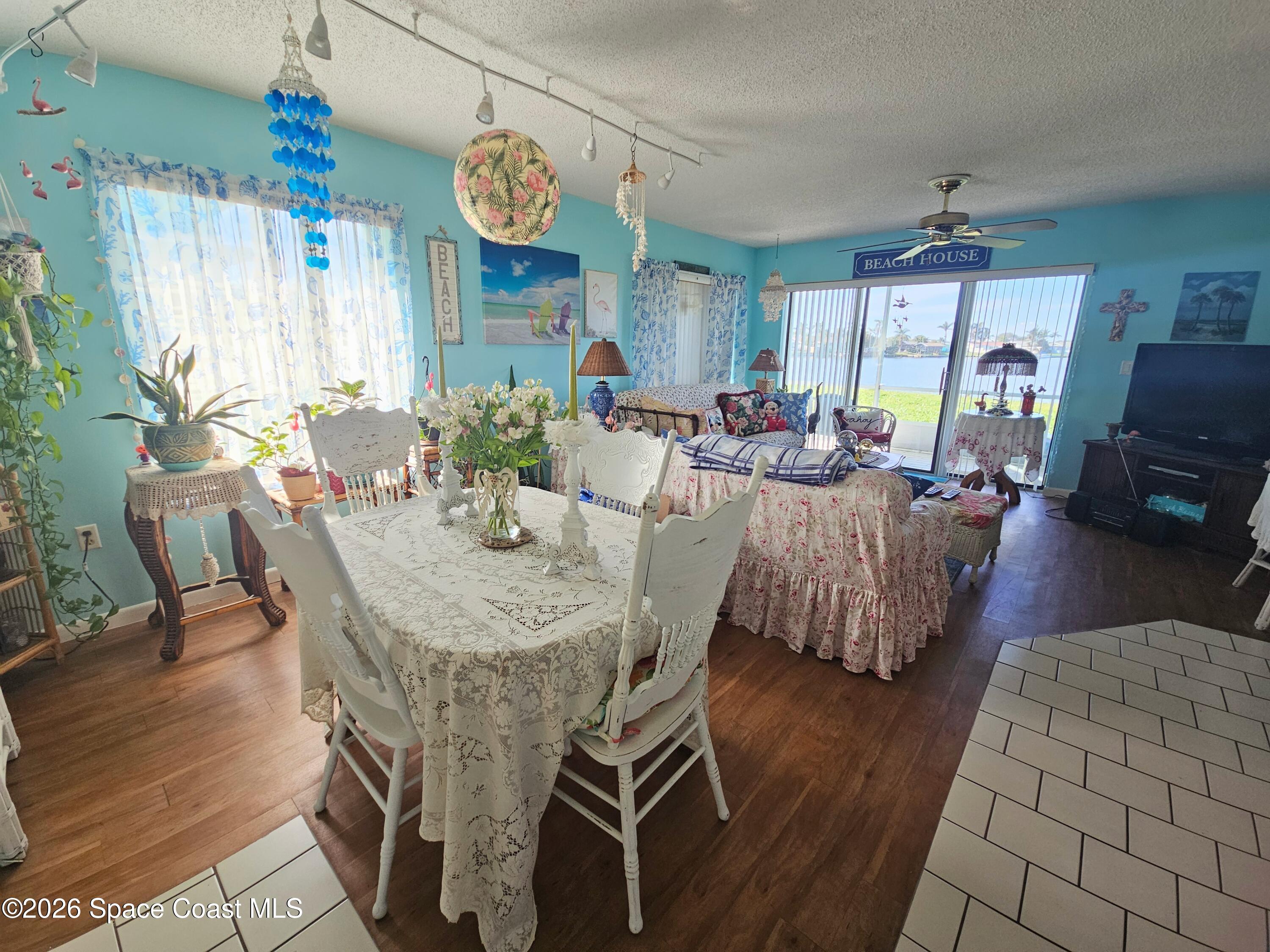 1750 Commodore Boulevard, Unit 2101 Cocoa Beach, FL 32931 - Photo 12 of 21 a view of a dining room with furniture window and wooden floor