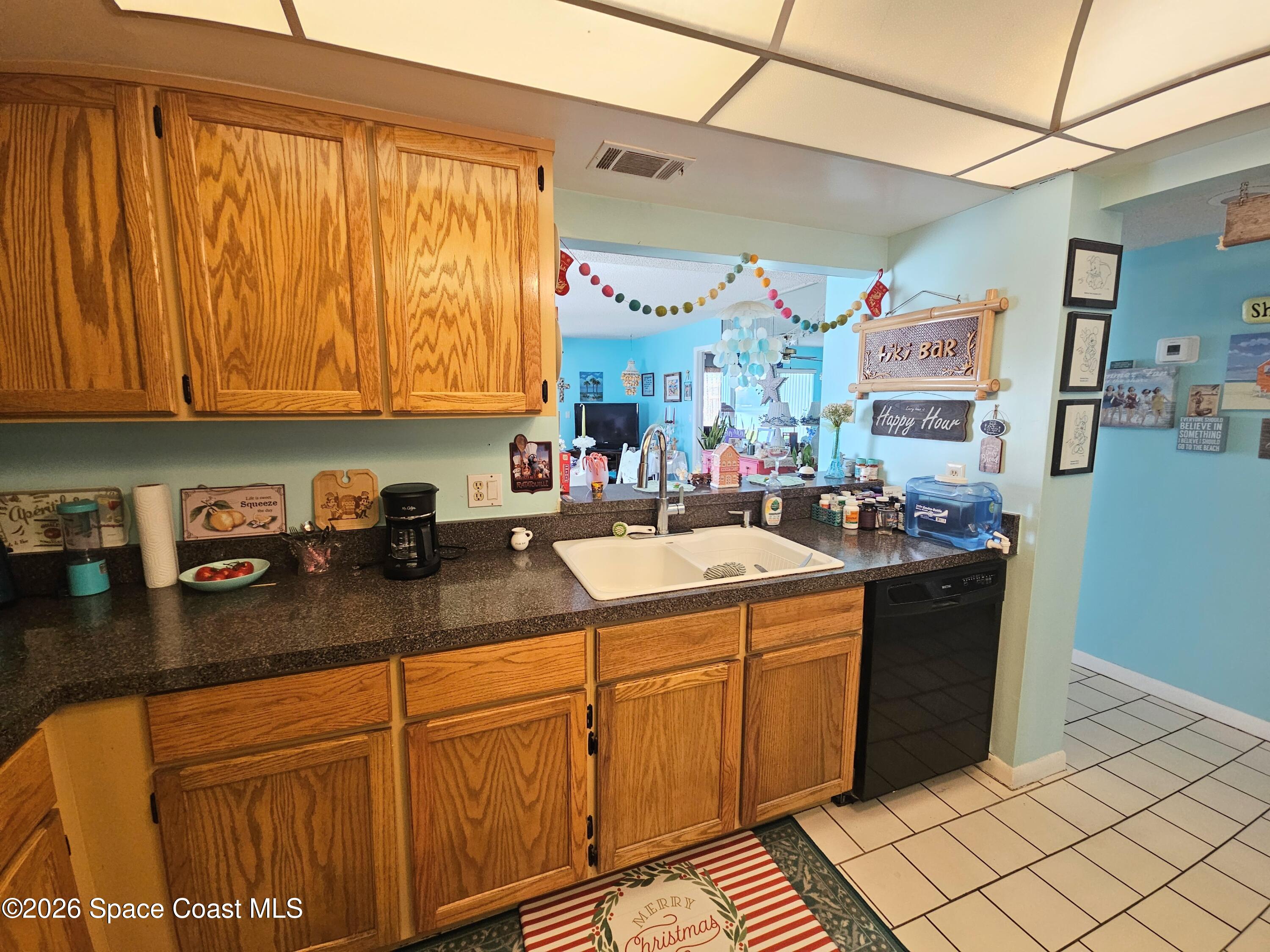 1750 Commodore Boulevard, Unit 2101 Cocoa Beach, FL 32931 - Photo 14 of 21 a kitchen with stainless steel appliances granite countertop a sink and cabinets